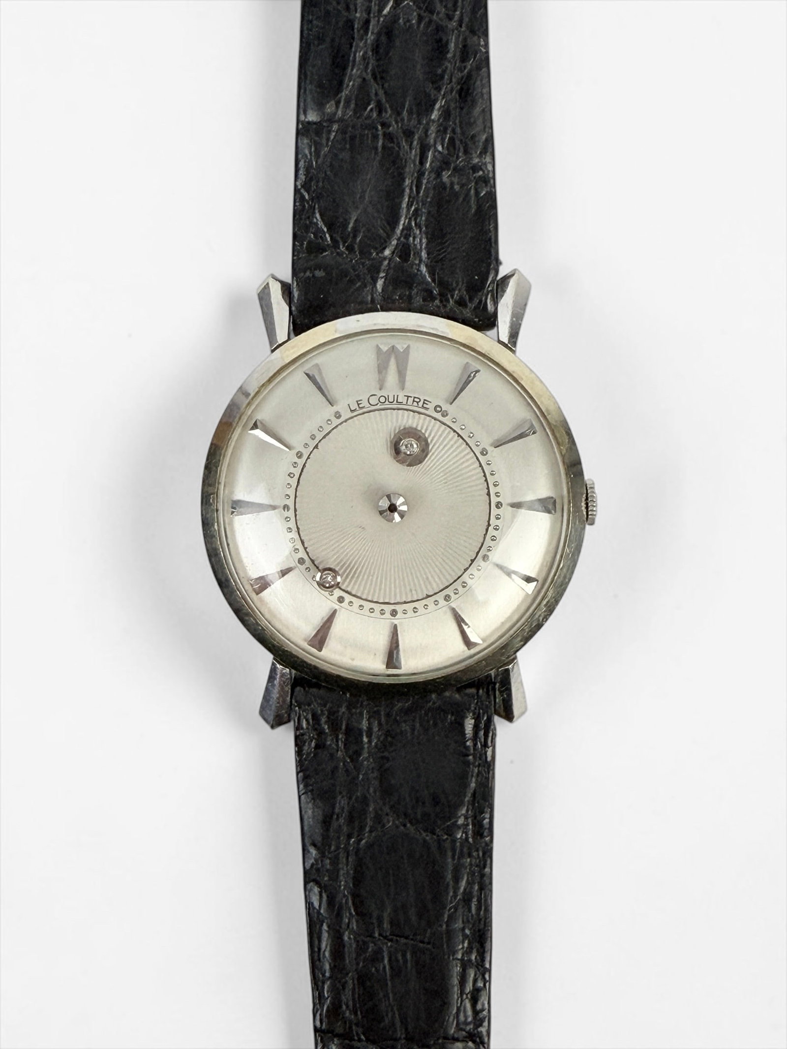 Vintage Le Coultre “Mystery Dial" Wristwatch: Total Weight: 27.13g Dimensions: 34mm Watch Face Length: 8 3/4" Long Band Condition: Wear and oxidation to the band. Minor scratches to the back and casing. Not tested for timekeeping.