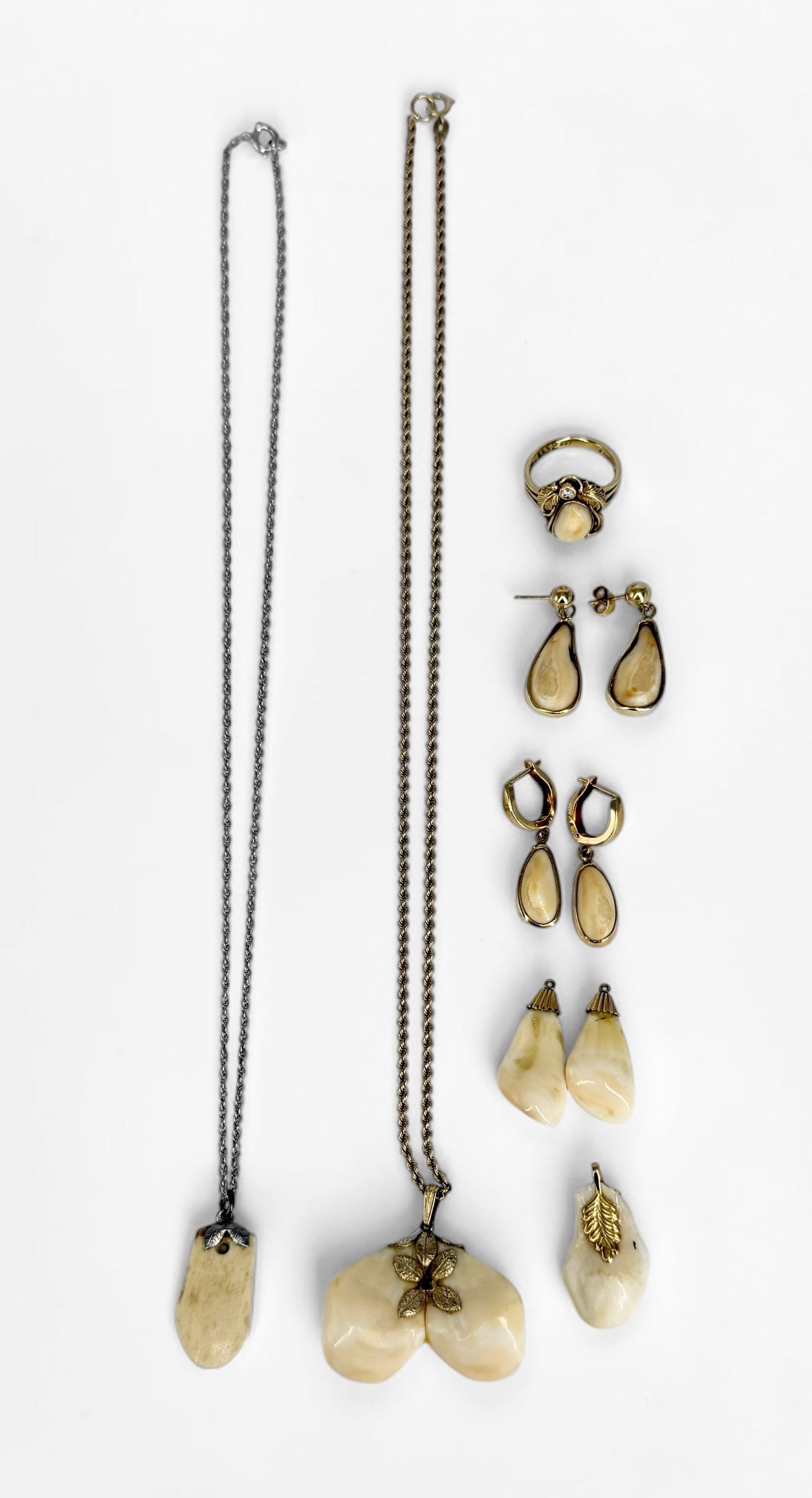 Group of 14K Gold & Silver Elks Tooth Jewelry: Includes extra Elk's teeth. Gold charm weighs 2.3g 14K Earrings are 14K gold, & the ring is marked 14K sterling. Condition: Good.