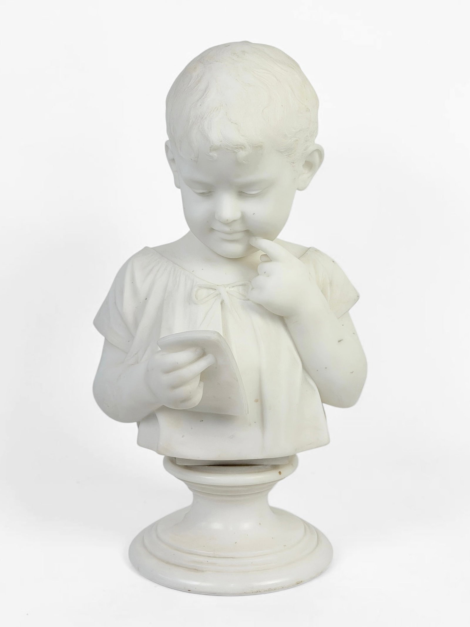 Cesare Lapini “Young Boy" Marble Sculpture: Signed and dated on verso. Date: 1894 Dimensions: 19" x 11" x 9" Condition: There is wear on the pedestal from the sculpture. Light surface marks to the marble surface, but the sculpture is overall in