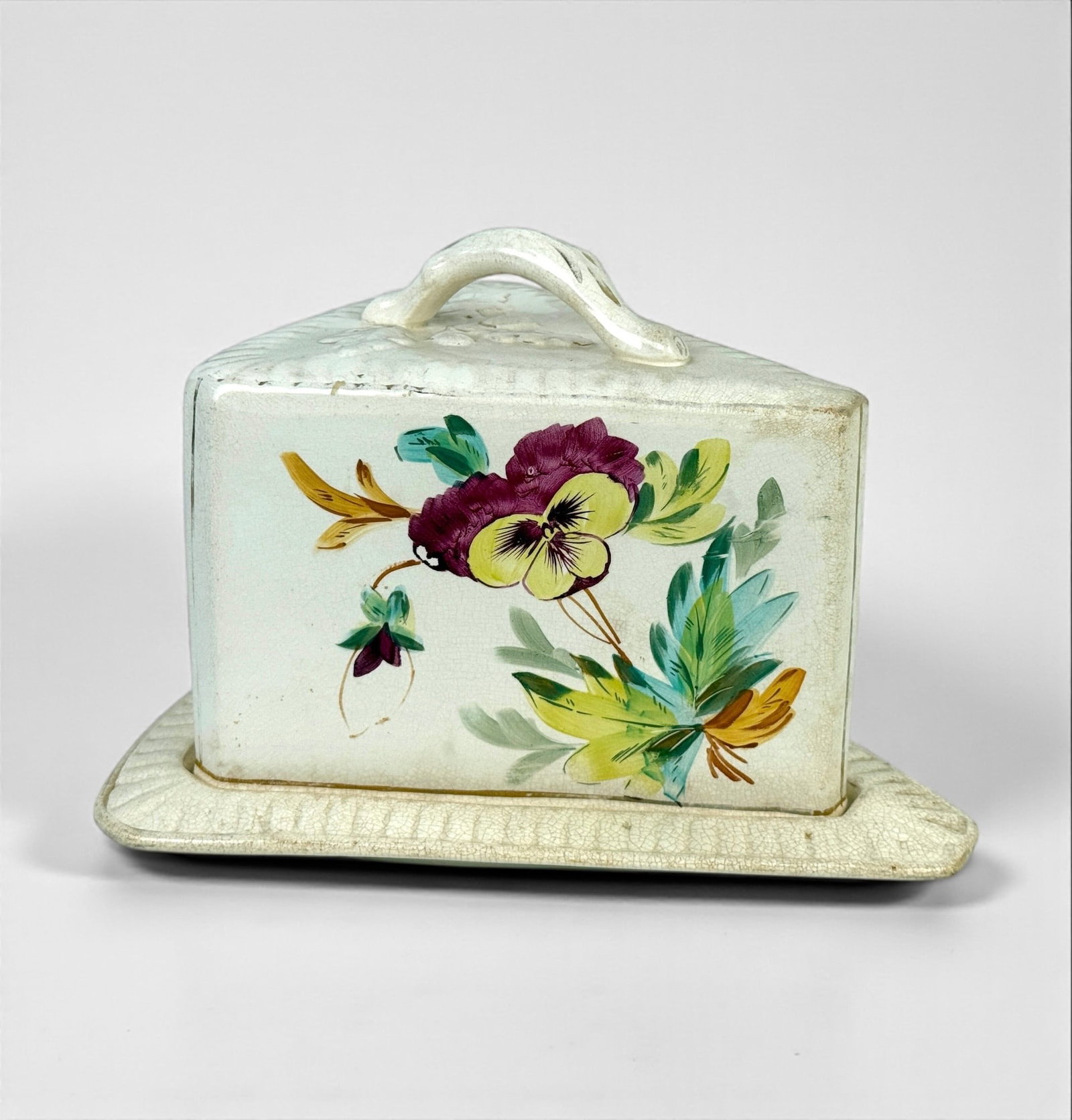 Antique Floral Cheese Dome: Height: 8"T x 11"L Condition: Crazing throughout the plate and dome. Staining and discoloration to the lower edges of the dome. No visible chips or cracks.