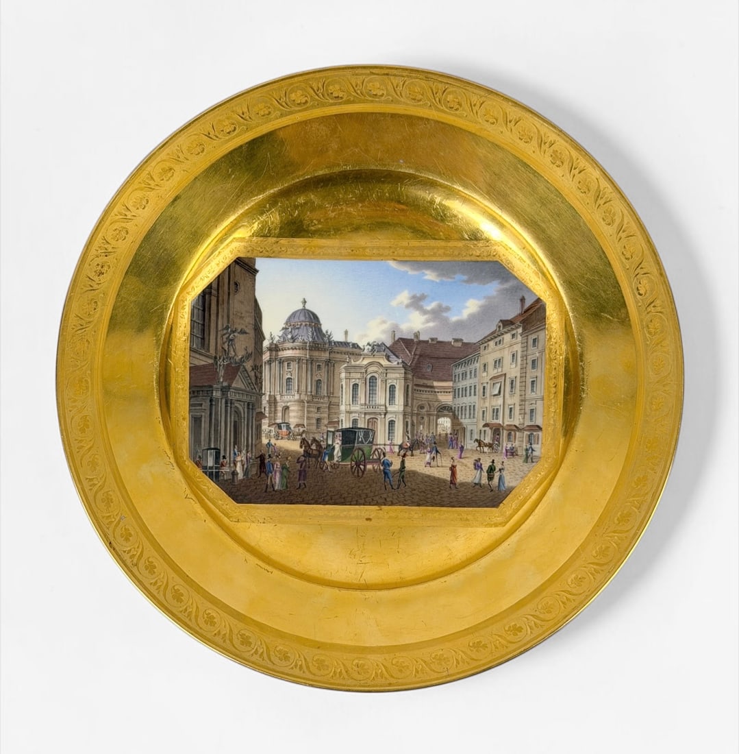 Royal Vienna “Vue de la Place de St. Michael" Gold Gilded Plate: Inscribed on the back. Dimensions: 10" Diameter Condition: Some scratches and surface marks to the gilding. Some signs of natural aging of the porcelain.