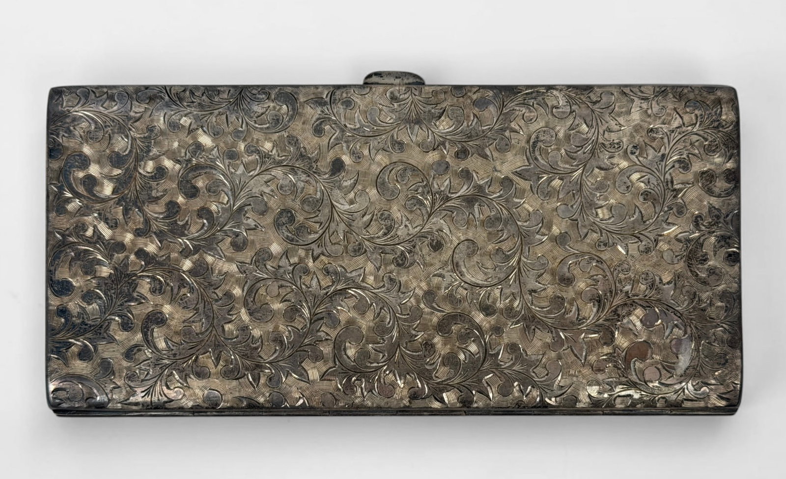 Vintage Ornate Sterling Cigarette Case: Dimensions: 3 1/2" x 7" when closed Condition: Tarnishing and surface scratches throughout. Monogrammed on the interior. 