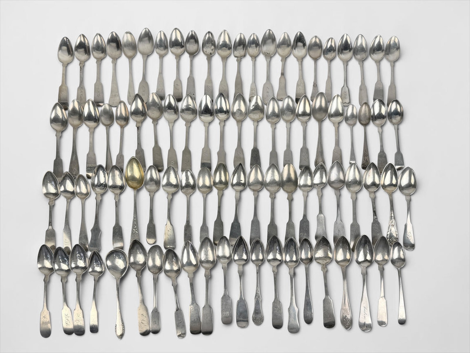 Large Assortment Of Antique Silver Teaspoons: A large assortment of makers and ages. The vast majority of teaspoons are fiddle-pattern in coin and sterling. Total Weight: 47.5 ozt Condition: Most fair to
