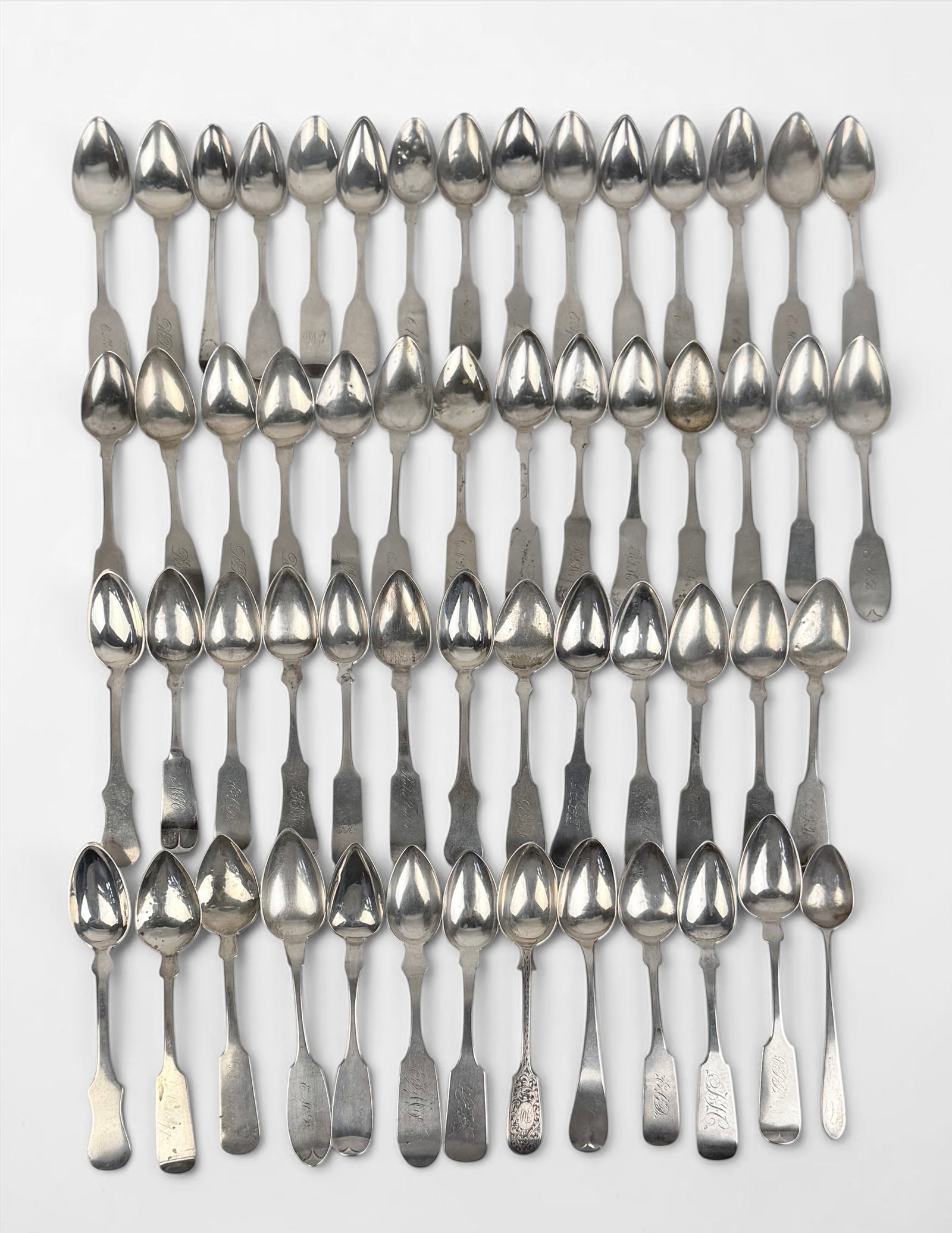 Assorted Antique Fiddle Pattern Silver Spoons: Various makers and ages. The vast majority are teaspoons Coin and Sterling Silver. Total Weight: 29.5 ozt Condition: Fair to Good with evidence of wear consistent with 