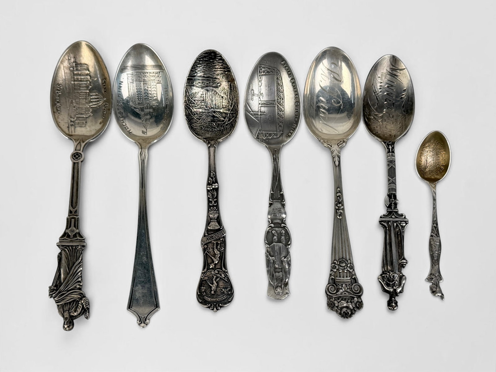 (7) Sterling Minnesota State Collectible Spoons: Total Weight: 4.2ozt Dimensions: Approx. 6" Long Condition: Minor tarnishing; otherwise, in good condition. Come in a rolled fabric case. 