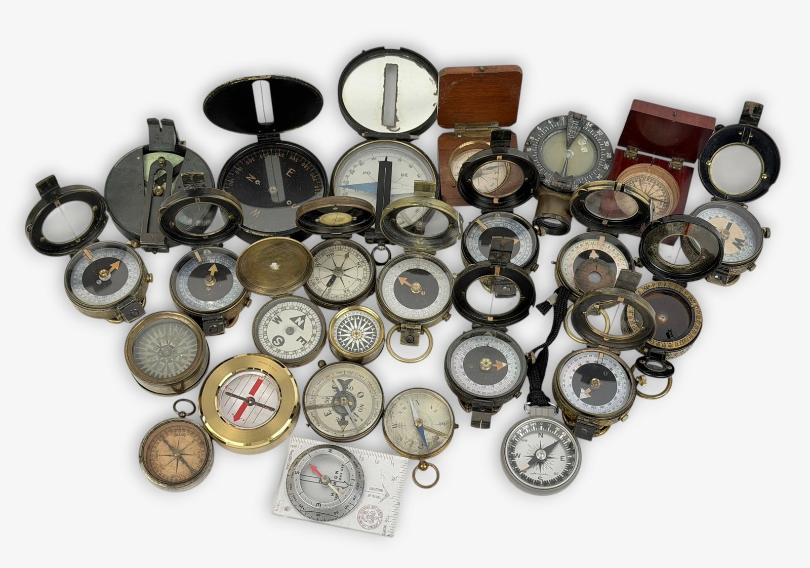 Group of (25) WWI Military Compasses (F): Size: 2" Diameter Condition: Mixed condition throughout with wear, tarnish, scratches, and scattered oxidation from age and use. Working but untested for accuracy. Please refer to the