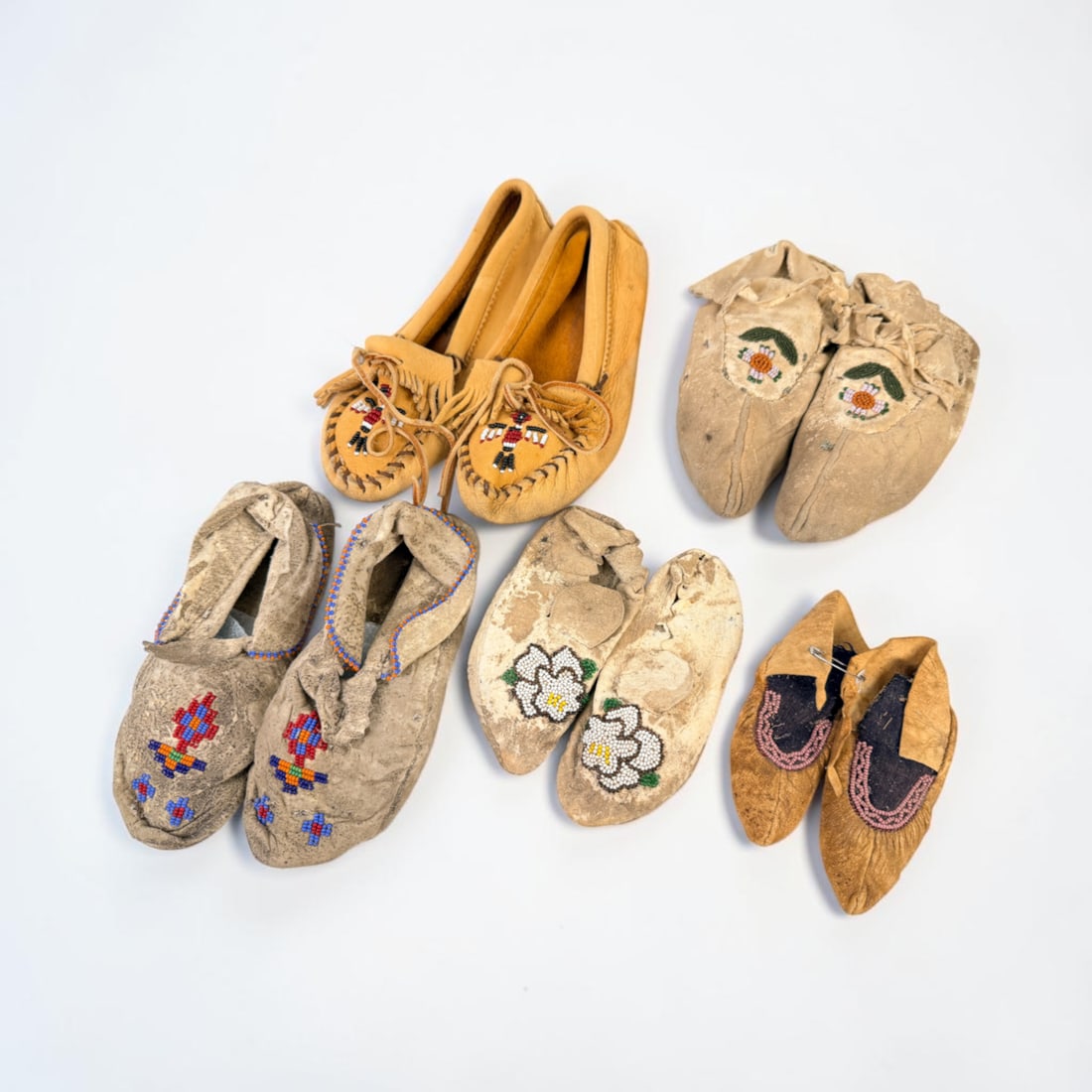 (5) Pairs of Child's Native American Beaded Hide Moccasins: The moccasins come in various sizing. Largest Pair: 9 1/2" Long Condition: The moccasins have various stages of wear and aging. Minor wear to the beading. Signs of a past