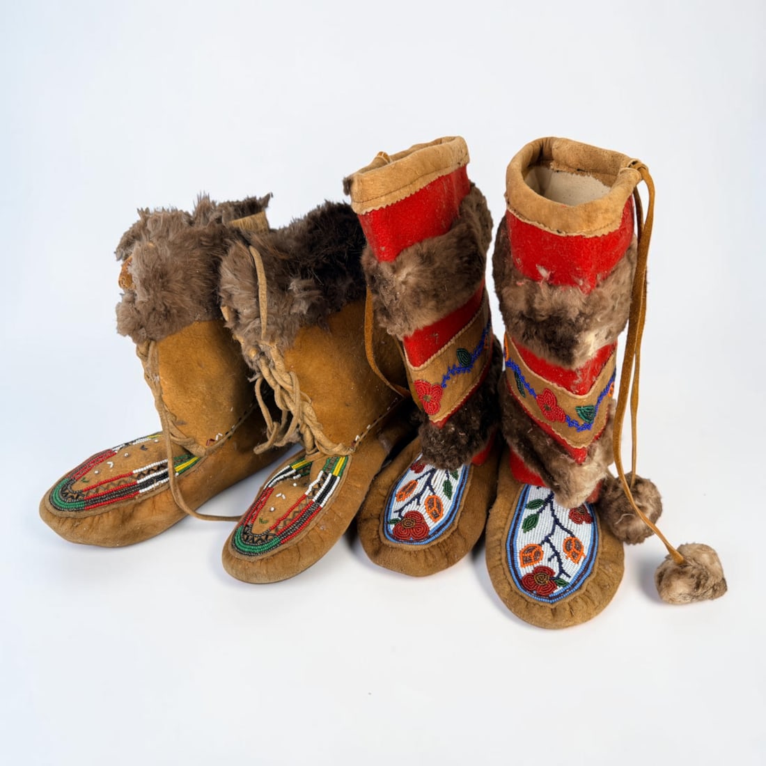 (2) Pairs of Native American Beaded & Fur Moccasins (D): Largest Pair: 11 1/2" Long Condition: Both pairs have wear and aging throughout. The fur is deteriorating throughout. Evidence of a past parasite infestation. Minor wear to the