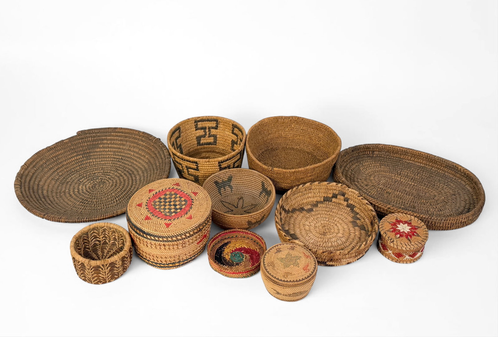 Large Group of Native American Wicker: 10 pieces included in the lot, one is a birch bark and porcupine quill box. Dimensions of Largest Piece: 12" Diameter Condition: The set has various levels of aging