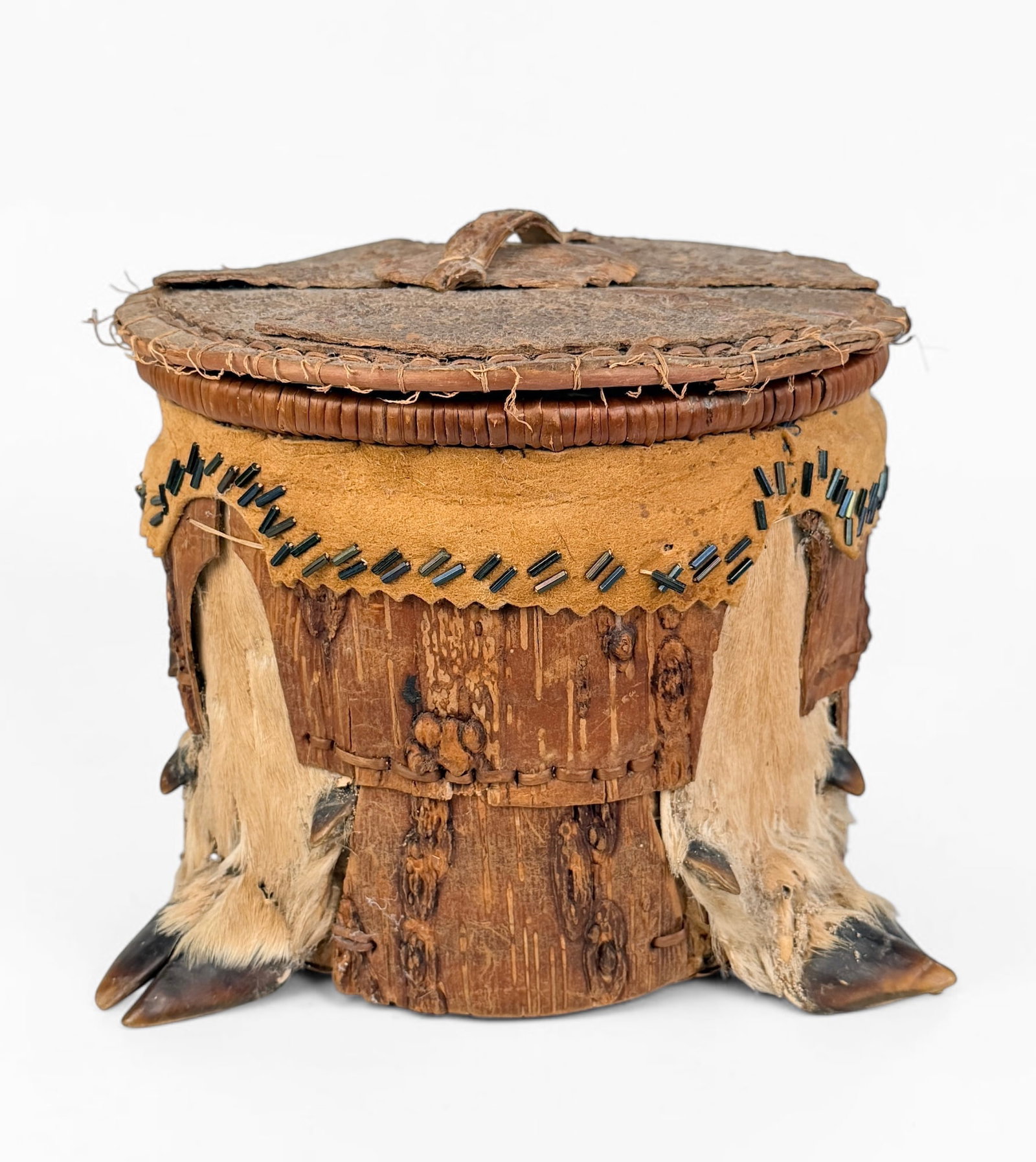 Native American Birch & Deer Hoof Lidded Box: Dimensions: 6" Tall x 7 1/2" Diameter Condition: There is some wear to the pieces of deer hide, with signs of past insect infestation that has worn away some areas of the hide.&