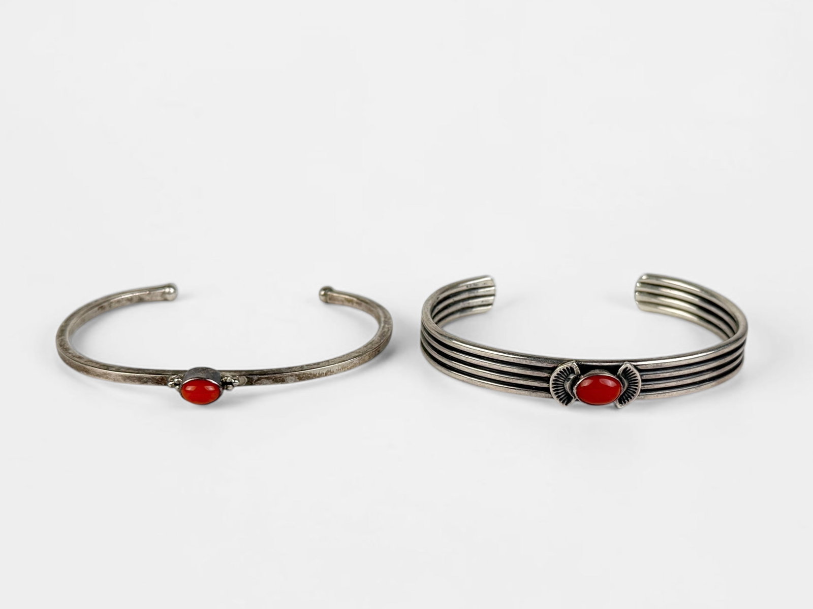 (2) Navajo Sterling Silver & Coral Cuffs: One cuff has the maker's mark SA on the interior. Size: Both 2 3/8" Interior Diameter, 1" Opening Total Weight: 30g Condition: Both cuffs are in good condition.&nbs