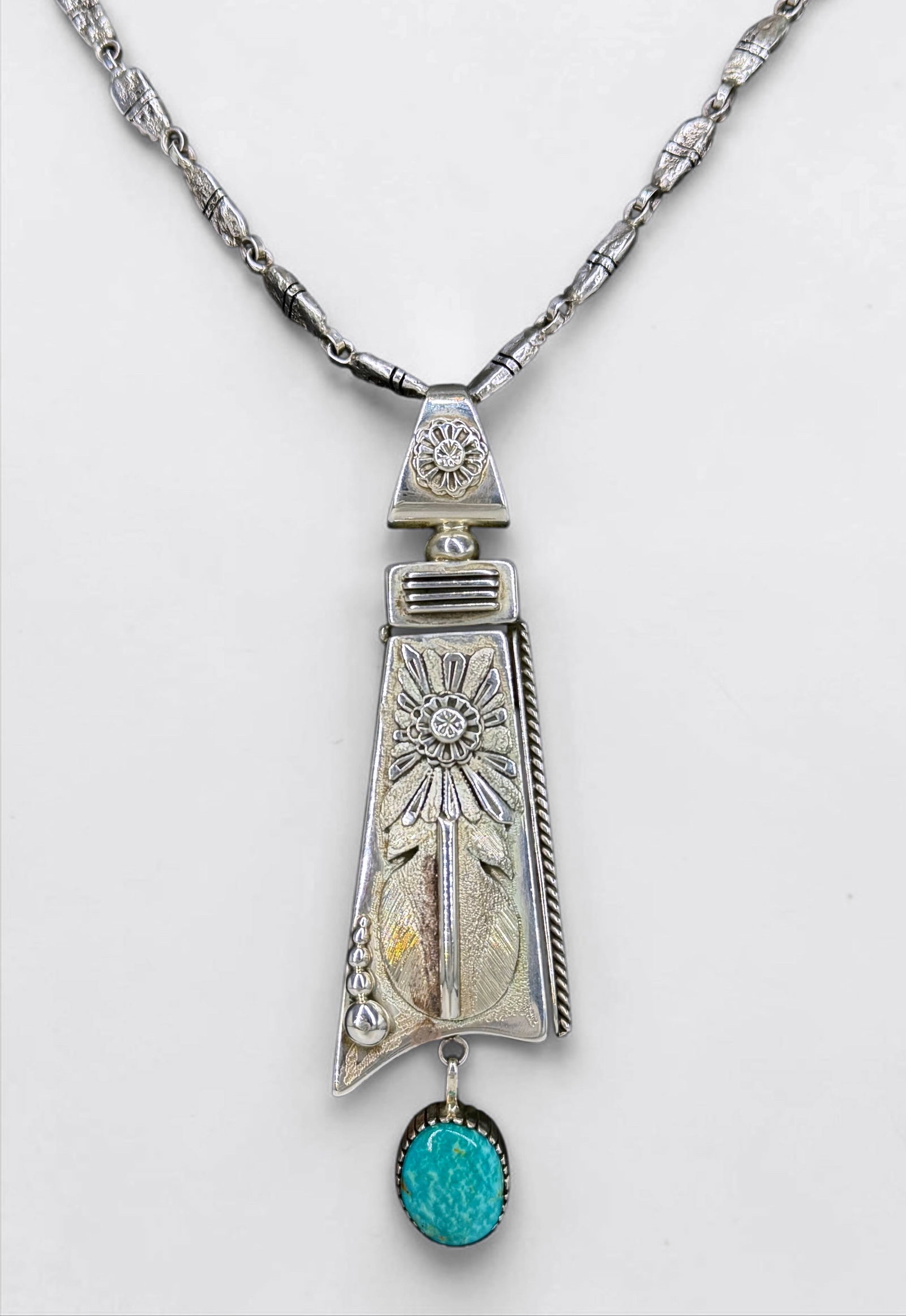 Ben Begaye Sterling Silver & Turquoise Necklace: Stamped on the reverse of the pendant. Total Weight: 84g Length: 29" Pendant: 4 1/2" x 1" Condition: The necklace is in good condition. 