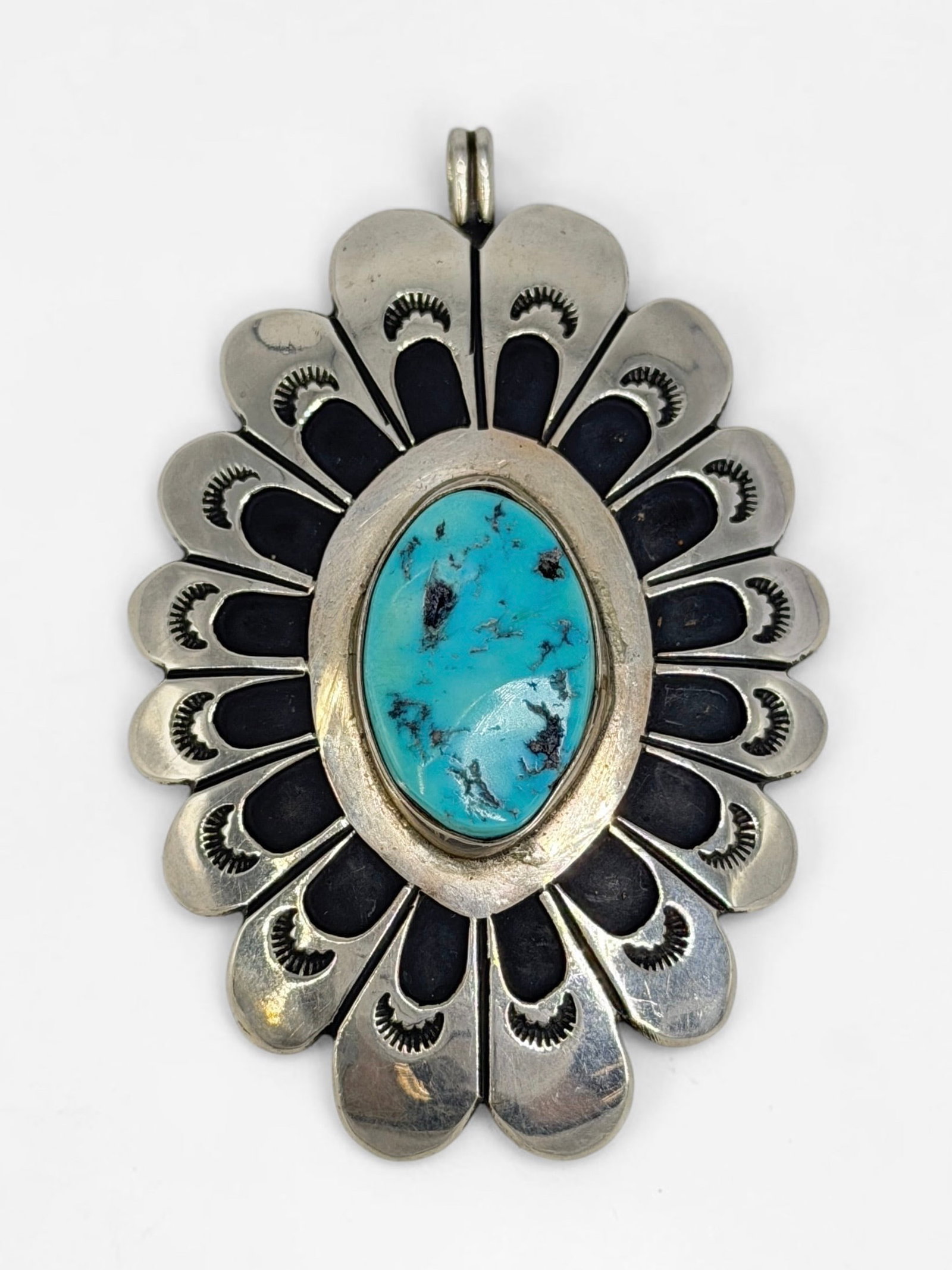 Tommy Singer Sterling Silver & Turquoise Pendant: Stamped on the reverse. Dimensions: 3" x 2" Total Weight: 31.68g Condition: The pendant is in good condition. Artist Bio: Tommy Singer (c. 1940-2