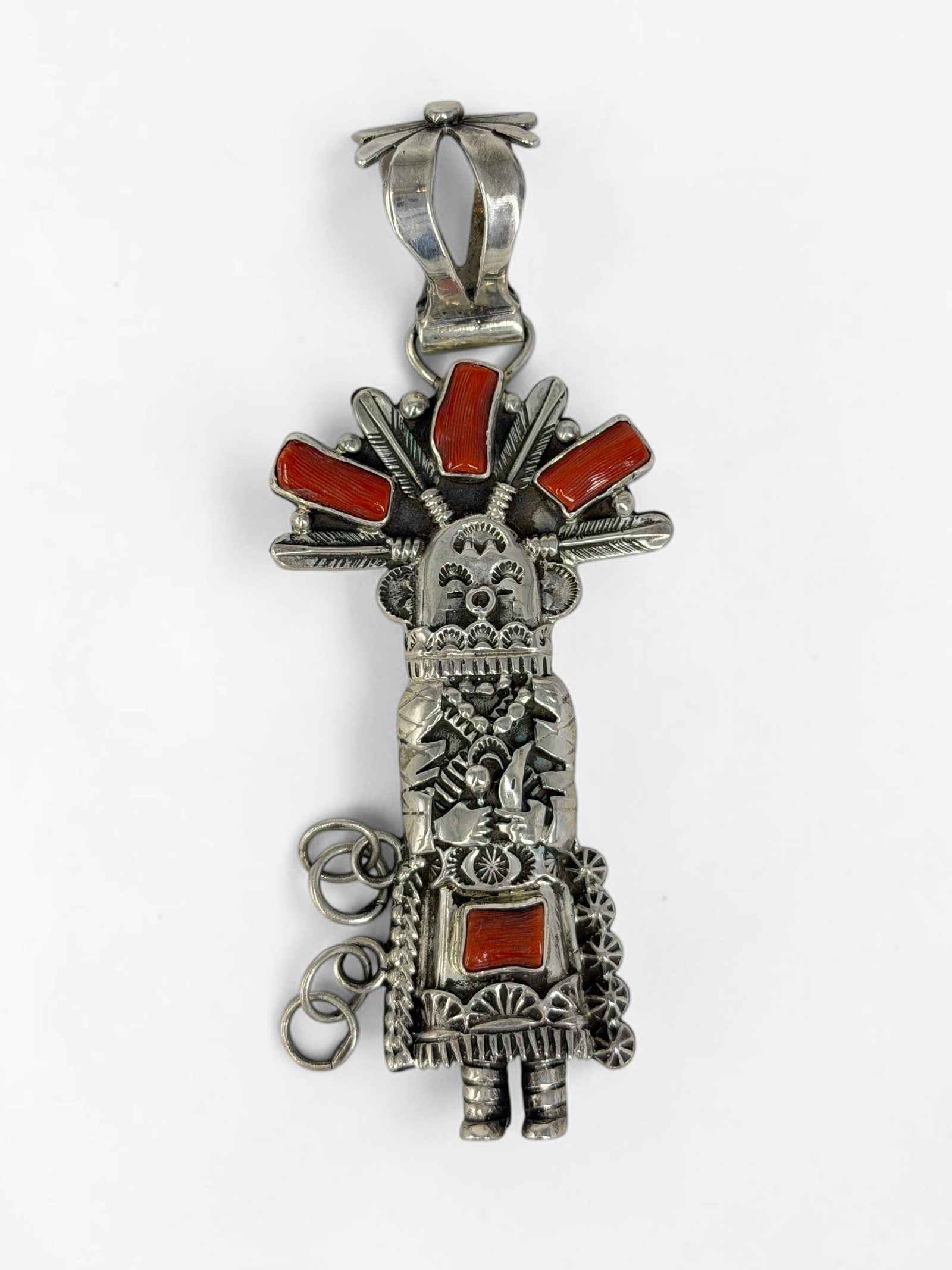 Daniel Mike Sterling Silver & Coral Kachina Pendant: Stamped on the reverse. Dimensions: 4" x 1 3/4" Total Weight: 48.4g Condition: The pendant is in very good condition. 