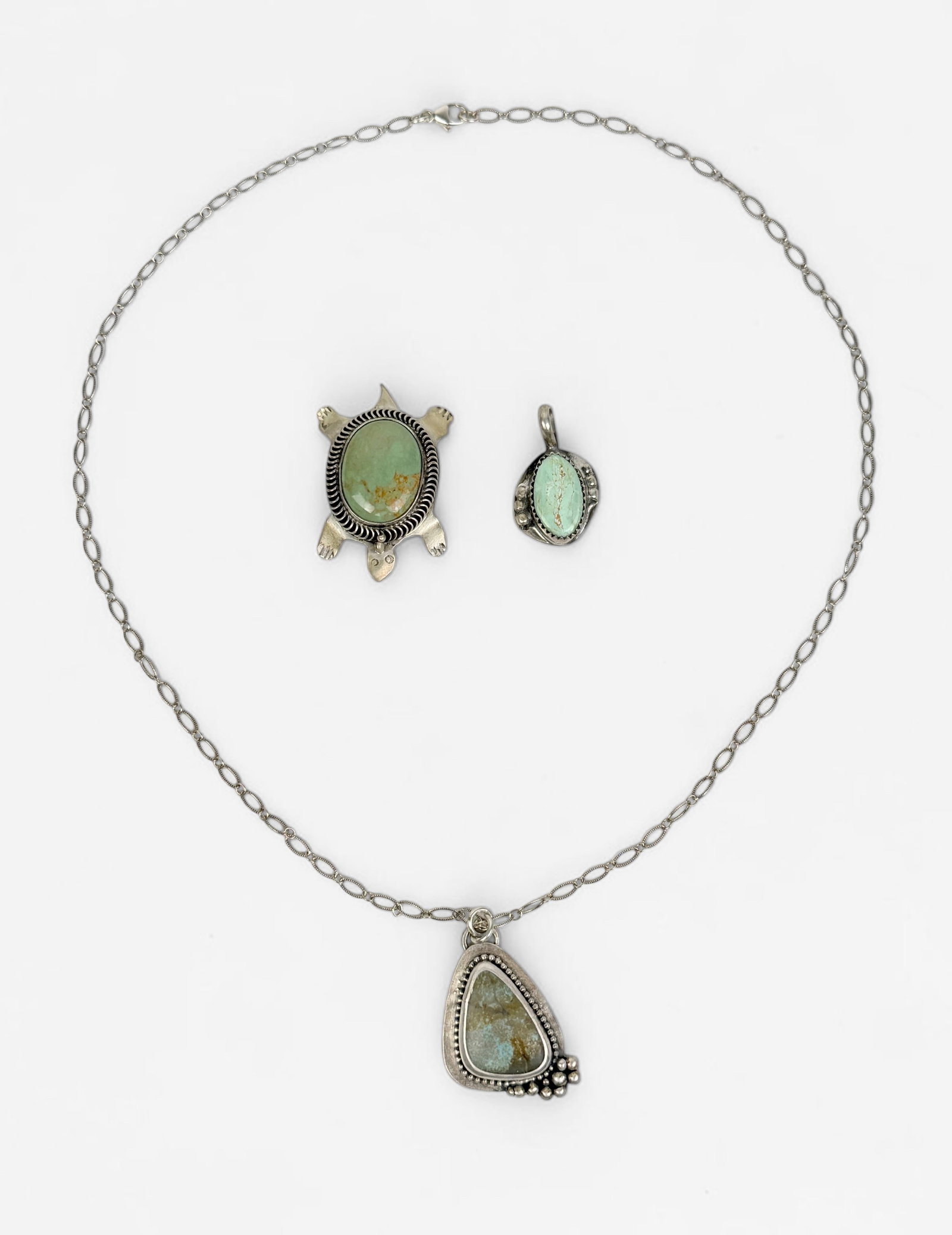 (2) Sterling & Turquoise Pendants and (1) Pin: Dimensions: 1 1/2" x 1" Largest Piece Total Weight: 18g Condition: Minor tarnishing throughout, overall, all pieces are in very good condition. 