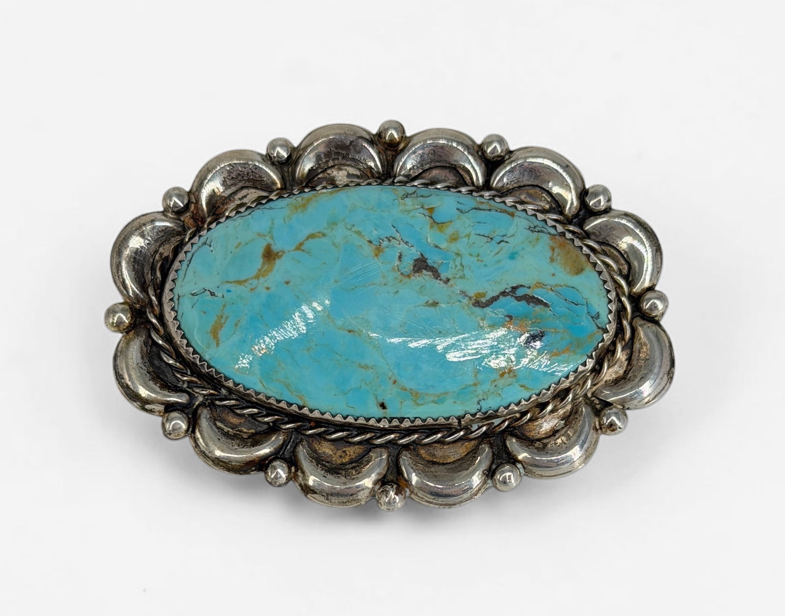 Cecil Lee Turquoise & Sterling Navajo Brooch: Stamped on the reverse. Dimensions: 2 1/2" x 1 3/4" Condition: Minor tarnishing of the sterling. Overall, the brooch is in good condition. 