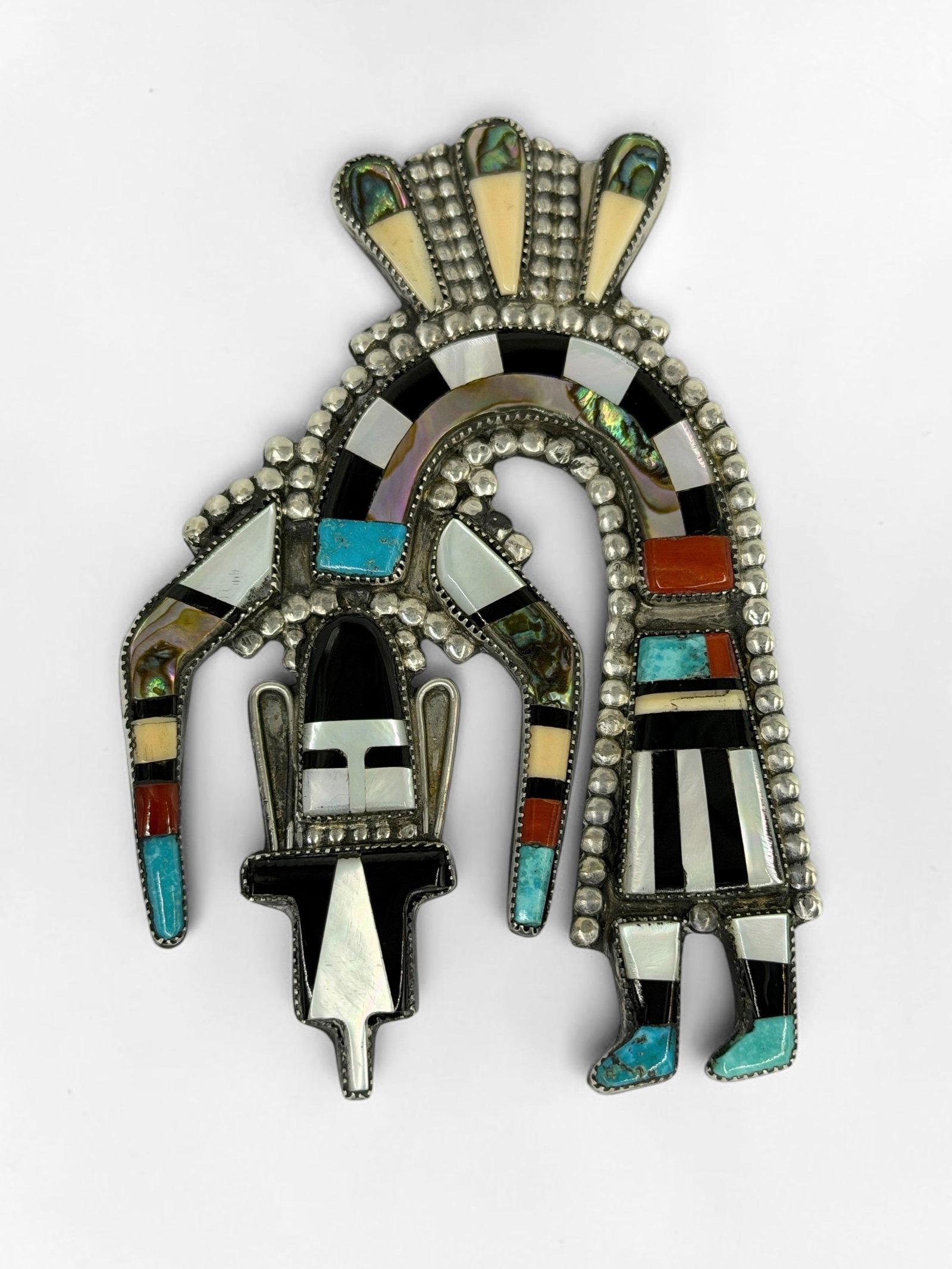 Zuni Silver & Multi-Stone Inlay Brooch: Stamped illegibly on the reverse of the clasp. Dimensions: 3 1/4" x 2 1/4" Total Weight: 32.88g Condition: The brooch is in good condition. 