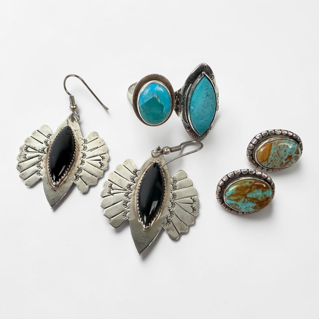 Group of Native American Sterling Jewelry: The lot includes (2) pairs of earrings and (2) rings. Dimensions of largest earrings: 1 1/2" Wide x 1 3/4" Tall Total Weight of All Pieces: 30.4g Condition: M
