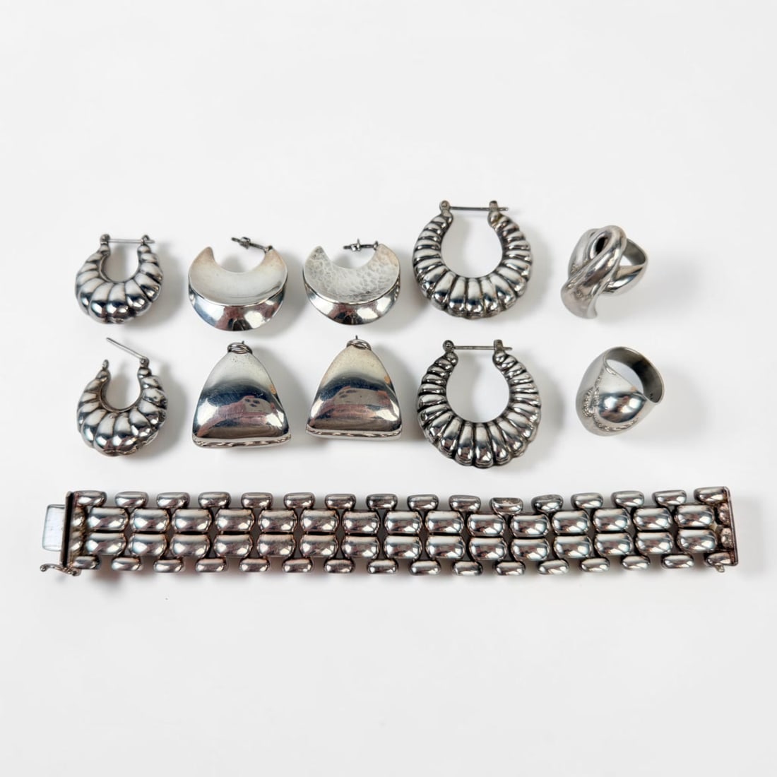 Group of Sterling Jewelry: The lot includes (1) bracelet, (2) rings, and (4) pairs of earrings. Length of Bracelet: 7" Total Weight of All Pieces: 115.6g Condition: Light tarnishing througho