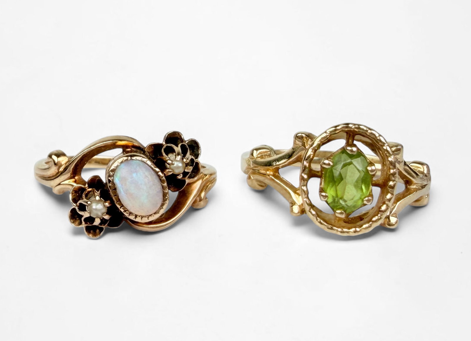 Pair of 14K Yellow Gold Opal & Peridot Rings: Size: 6 & 4 Total Weight: 5g Condition: The rings are in very good condition. One ring has a sizer attached. Please see images for details. 