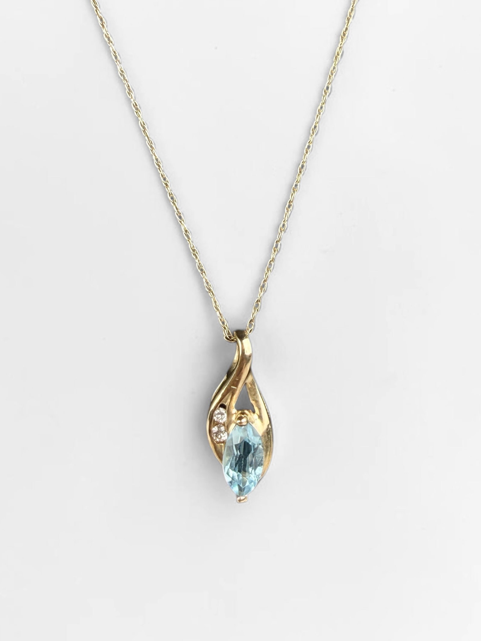 10K Yellow Gold & Blue Topaz Necklace: Length: 19" Pendant: 16.8mm x 6.8mm Total Weight: 1.2g Condition: The necklace is in very good condition. Please see images for details. 