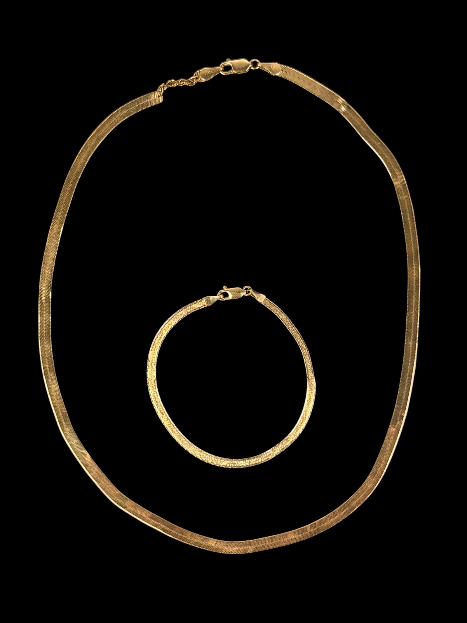 14K Yellow Gold Herringbone Necklace & Bracelet: Length of Necklace: 18" Length of Bracelet: 7" Total Weight: 10.2g Condition: There are kinks in the herringbone links in both the bracelet and the necklace. The necklace 