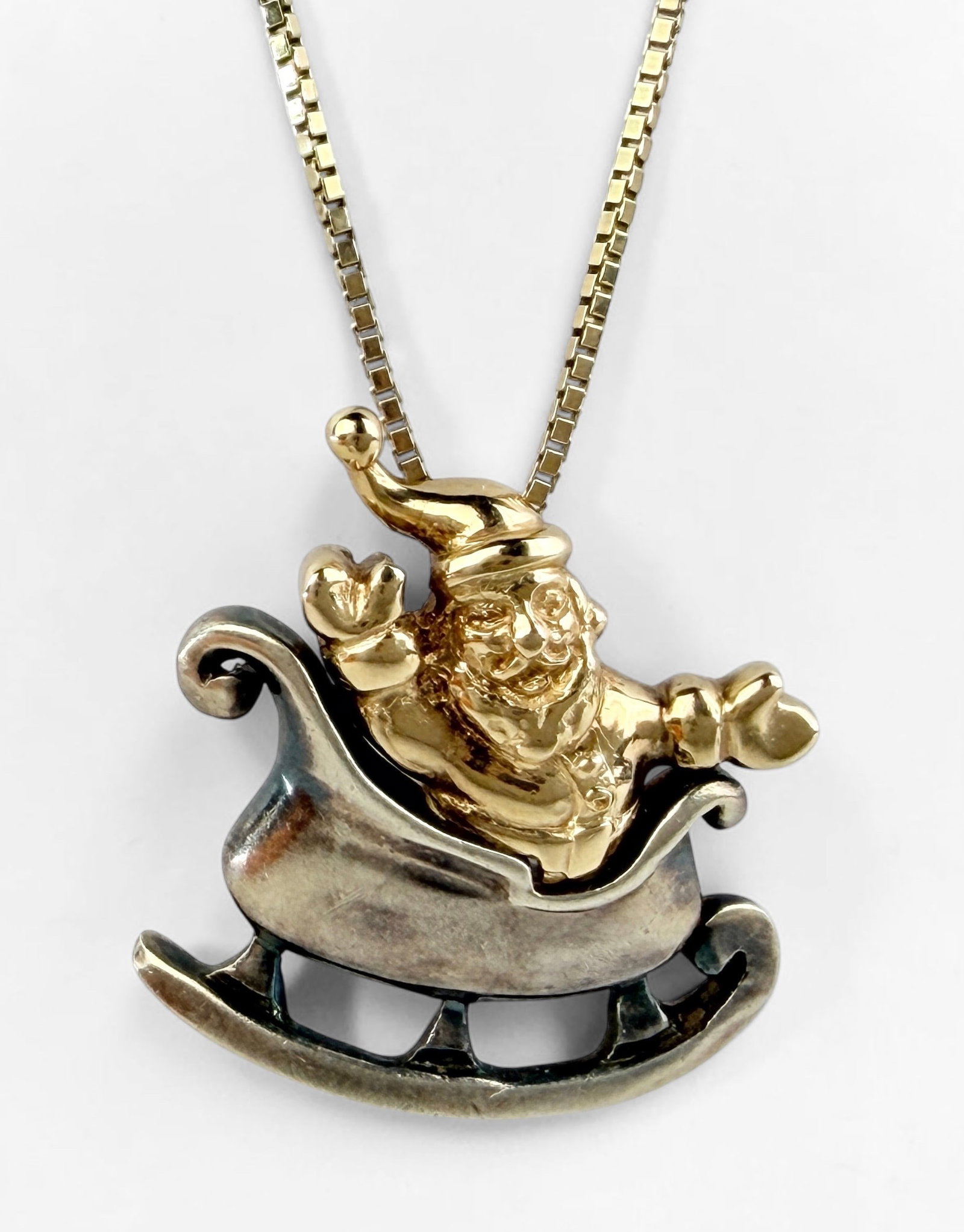 14K Yellow Gold & Sterling Santa Necklace: Length: 18" Pendant: 24mm x 22mm Total Weight: 7.2g Condition: The necklace has minor tarnishing to the sterling elements; otherwise, it is in good condition. Please see