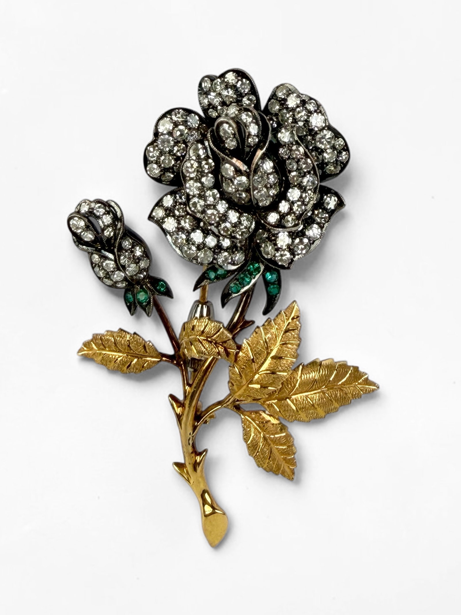 18K Yellow Gold w/ (2 CTTW) Diamond & Emerald Rose Brooch: Diamonds are tested; metal tests as 18K gold Dimensions: 2 3/4" x 2" Total Weight: 20.2g Condition: Tarnishing on the metal filigree of the rose petals. Overall, the brooch is i