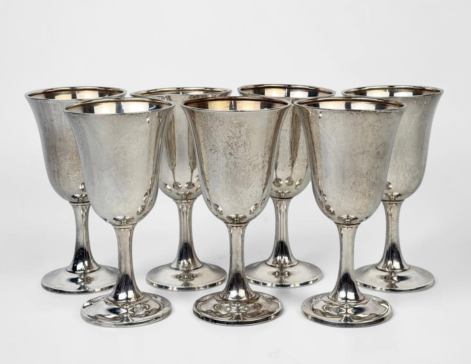 (7) Wallace Sterling Silver Cups: Total Weight: 33.93ozt Dimensions: 6 1/2" Tall x 3 1/2" Diameter Condition: There are minor dents to several of the cups. Most are slight misshapes. Surface scratches throughout
