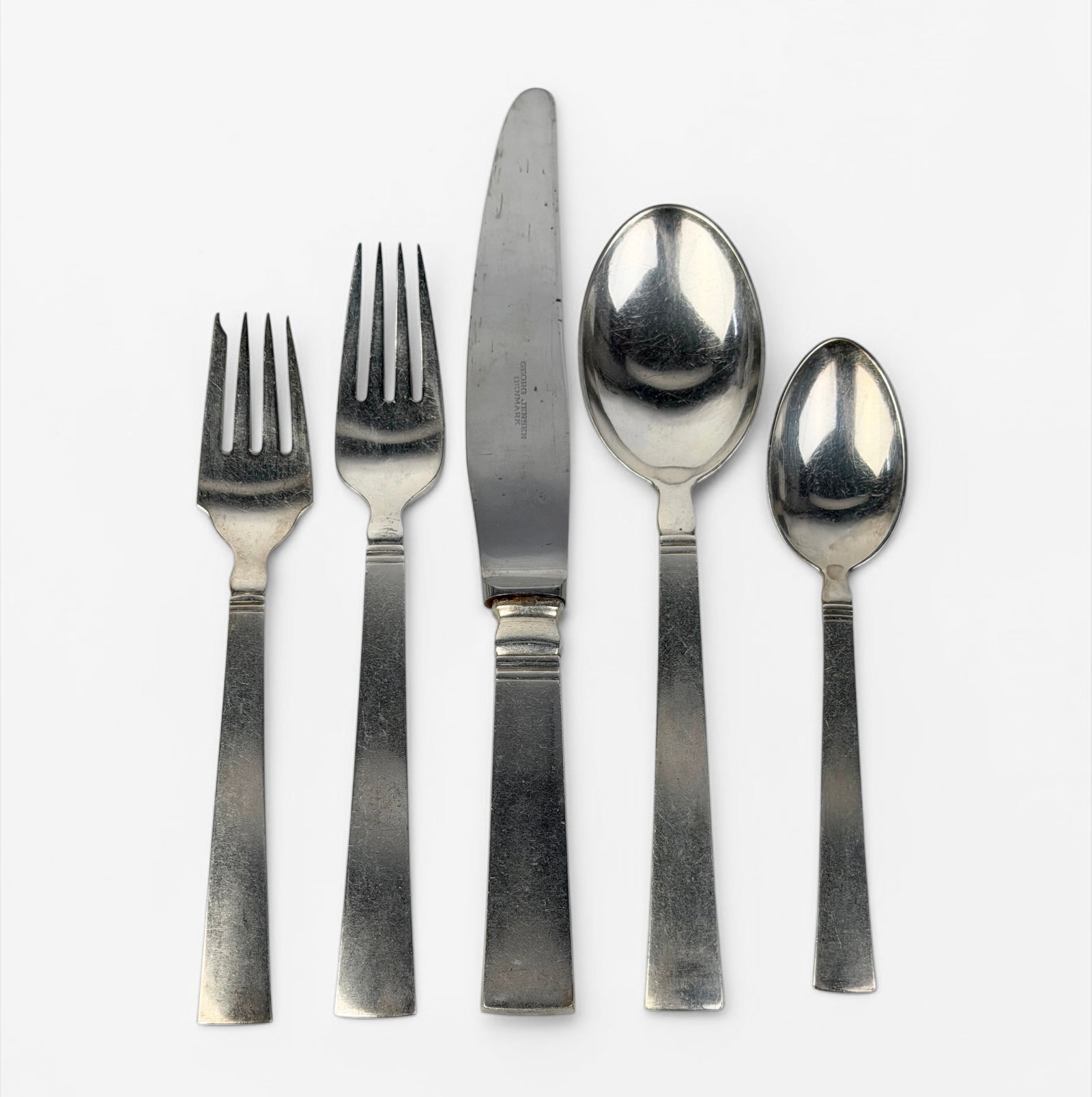 (54pc) Georg Jensen "Acadia" Sterling Flatware Set: 8 Dinner Knives (9" Long) 8 Butter Knives (5 1/2" Long) 8 Dinner Forks (7" Long) 8 Salad Forks (6 1/2" Long) 8 Soup Spoons (7" Long) 8 Tea Spoons (6" Long) 2 Serving Spoons (8" Long) 2 Sugar Spoons