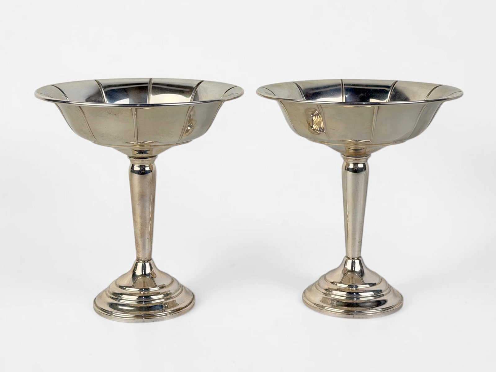 Pair of Sterling Weighted Compotes: Dimensions: 6" tall x 5 1/2" Diameter Condition: Light surface marks and scratches. Minor tarnishing consistent with the natural aging of silver. 