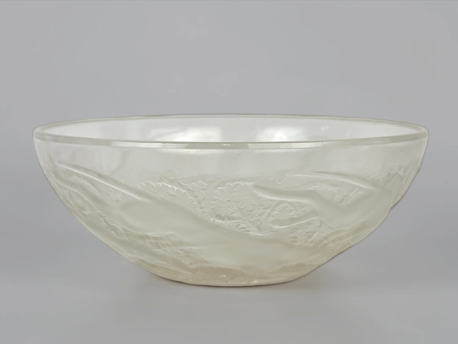 R. Lalique "Chiens" Glass Bowl: Stamped Lalique in the center of the bowl. Dimensions: 9 1/2" Diameter Condition: The bowl is in very good condition. About: Rene Lalique (1860–1945) was