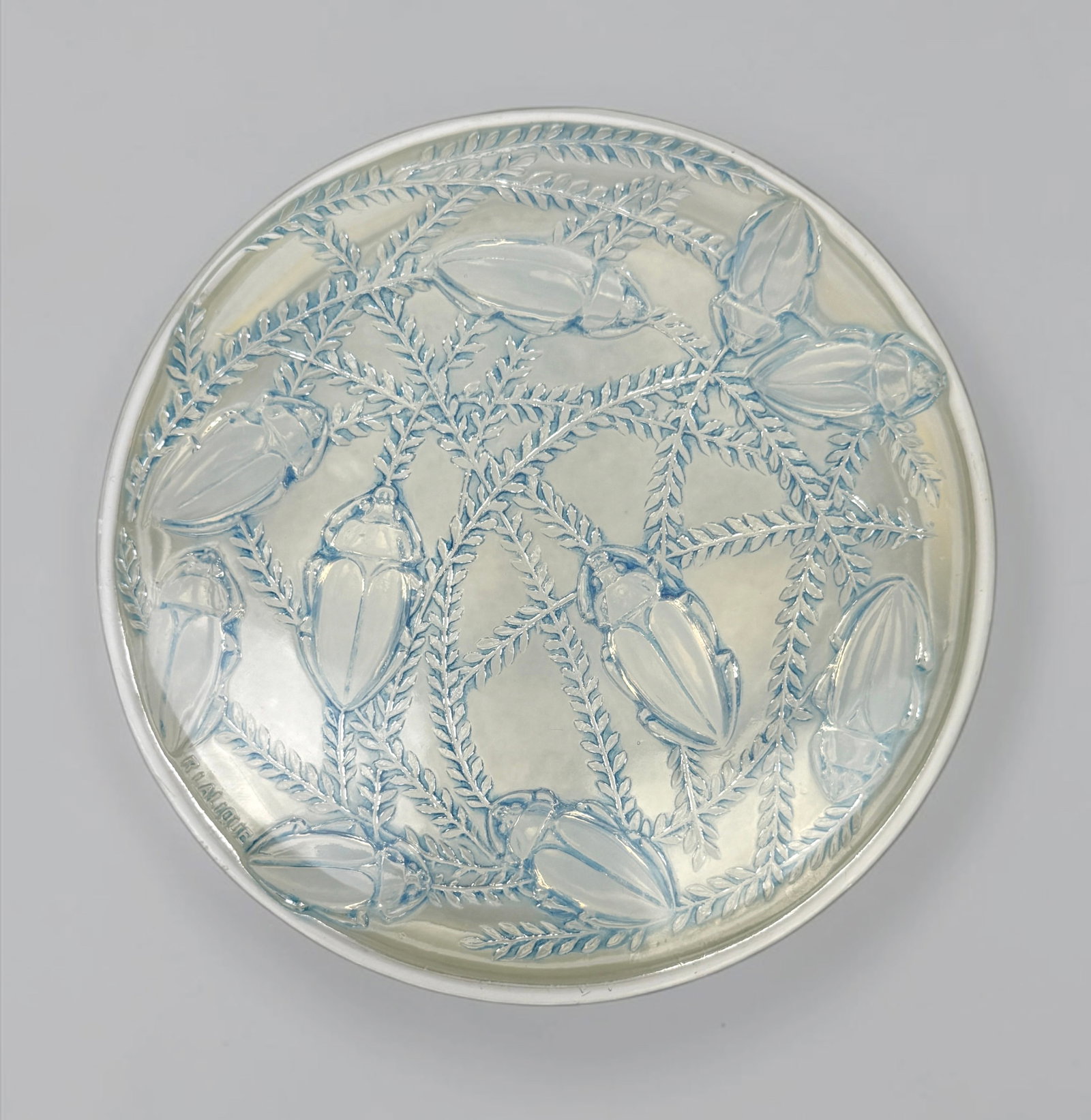 Lalique "Cleones" Opalescent Glass Powder Box: Marked Lalique on the edge. Dimensions: 2" Tall x 6 1/2" Diameter Condition: There are small chips on the edge of the lid. Otherwise, the powder box is in very