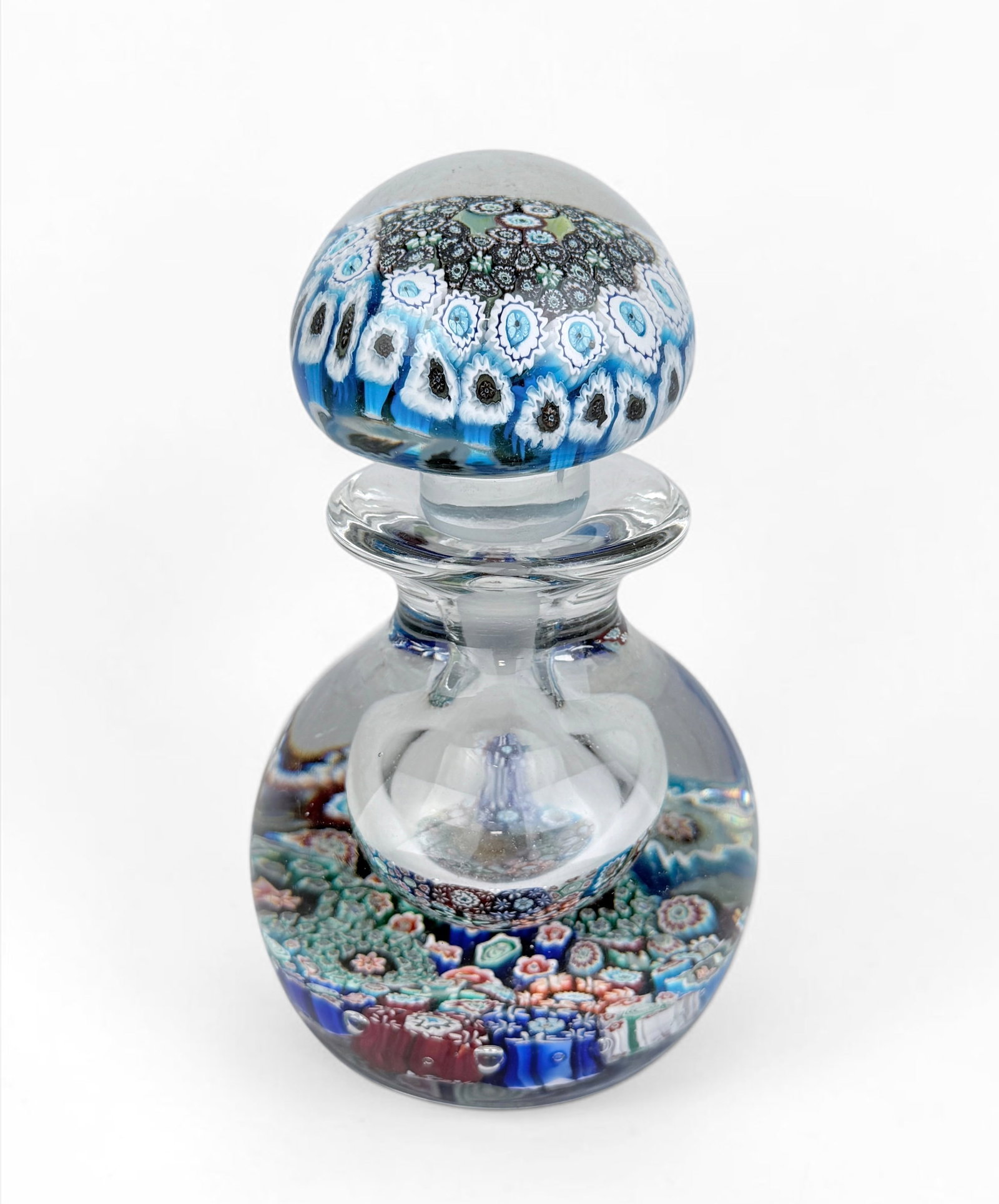 Millefiori Murano Art Glass Perfume Bottle: Dimensions: 6 1/2" Tall x 3 3/4" Diameter Condition: Minor chips to the stopper. There is residue in the well, consistent with previous use. Overall, the perfume bottle presents