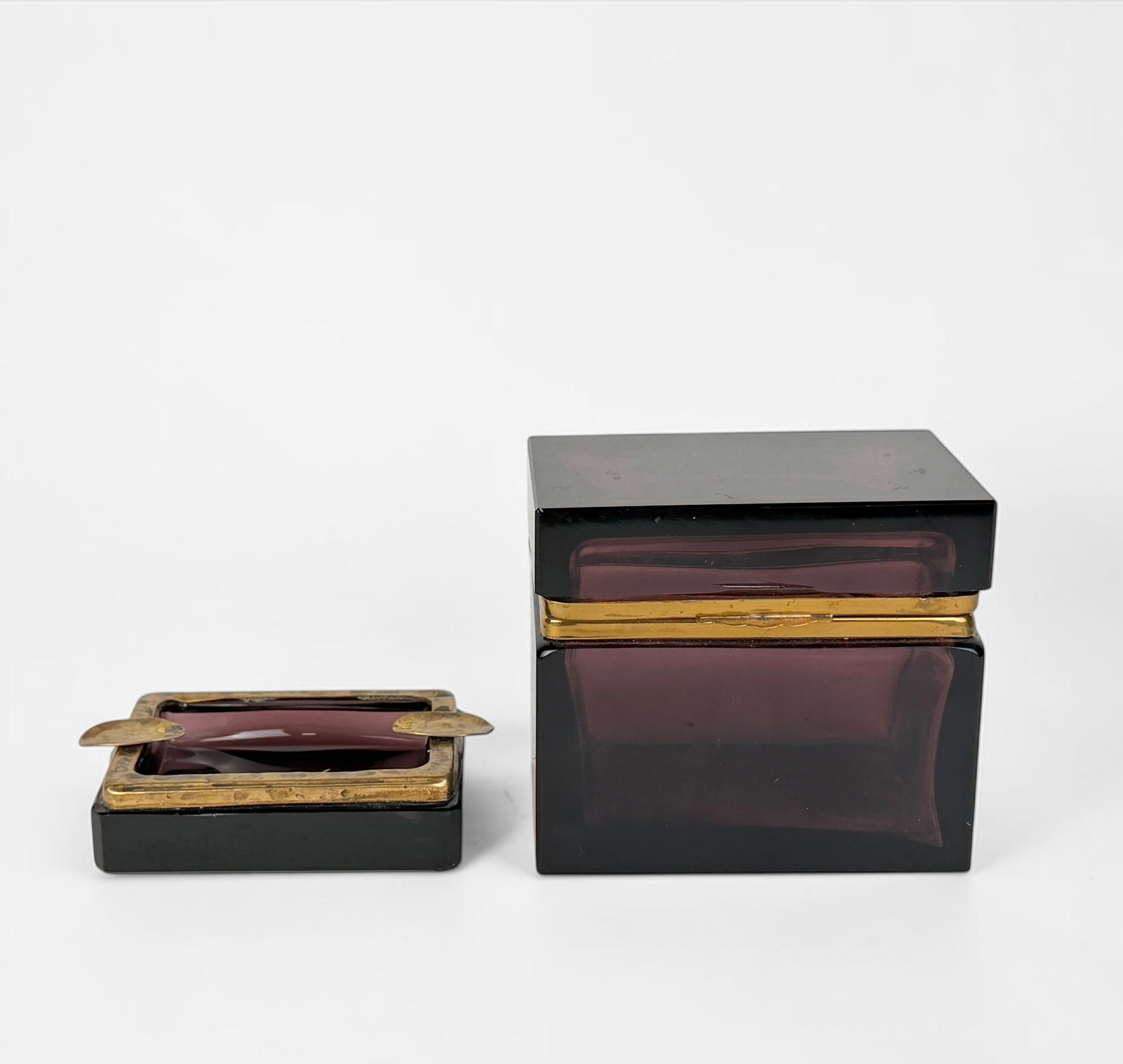 Murano-Style Purple Glass Box & Ashtray: Dimensions: 4 1/2" x 5" x 3" Box Condition: The box has a fleabite chip to the front left corner. Surface scratches throughout both the box and ashtray. Wear and tarnishing