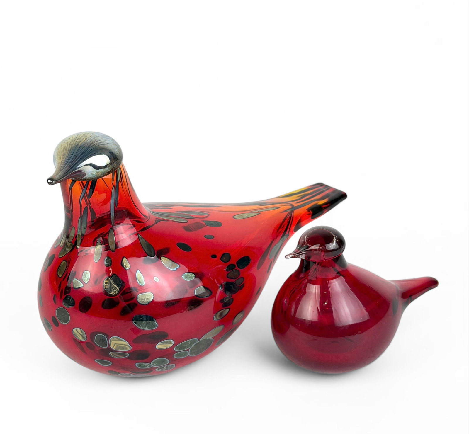 Pair of Ruby Red "Rubiinilintu" Iittala Toikka Birds: Both birds are signed by the artist on the bottom and have the Iittala stickers. Dimensions: 5" x 8" x 3 1/2" Largest Bird Condition: Both birds are in very good con