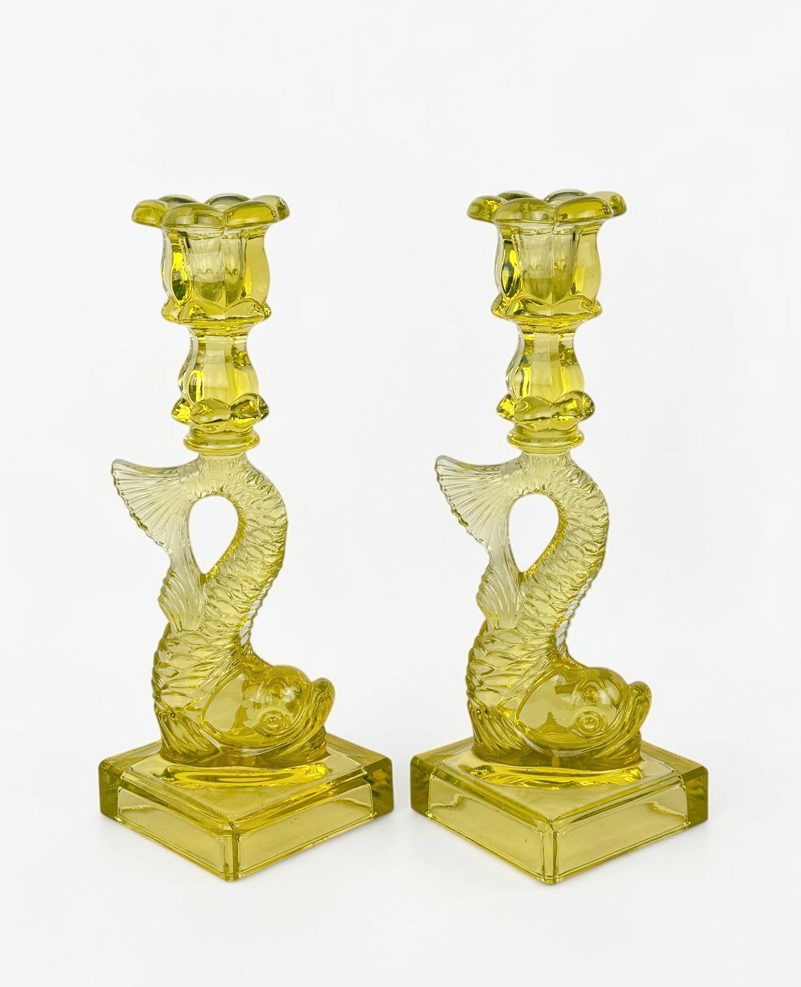 Pair of MMA "Dolphin" Uranium Glass Candlesticks (B): Marked on the bottom as "MMA" Dimensions: 10 1/2" Tall x 3 3/4" Wide Base Condition: The candlesticks are in very good condition. See images for details. 