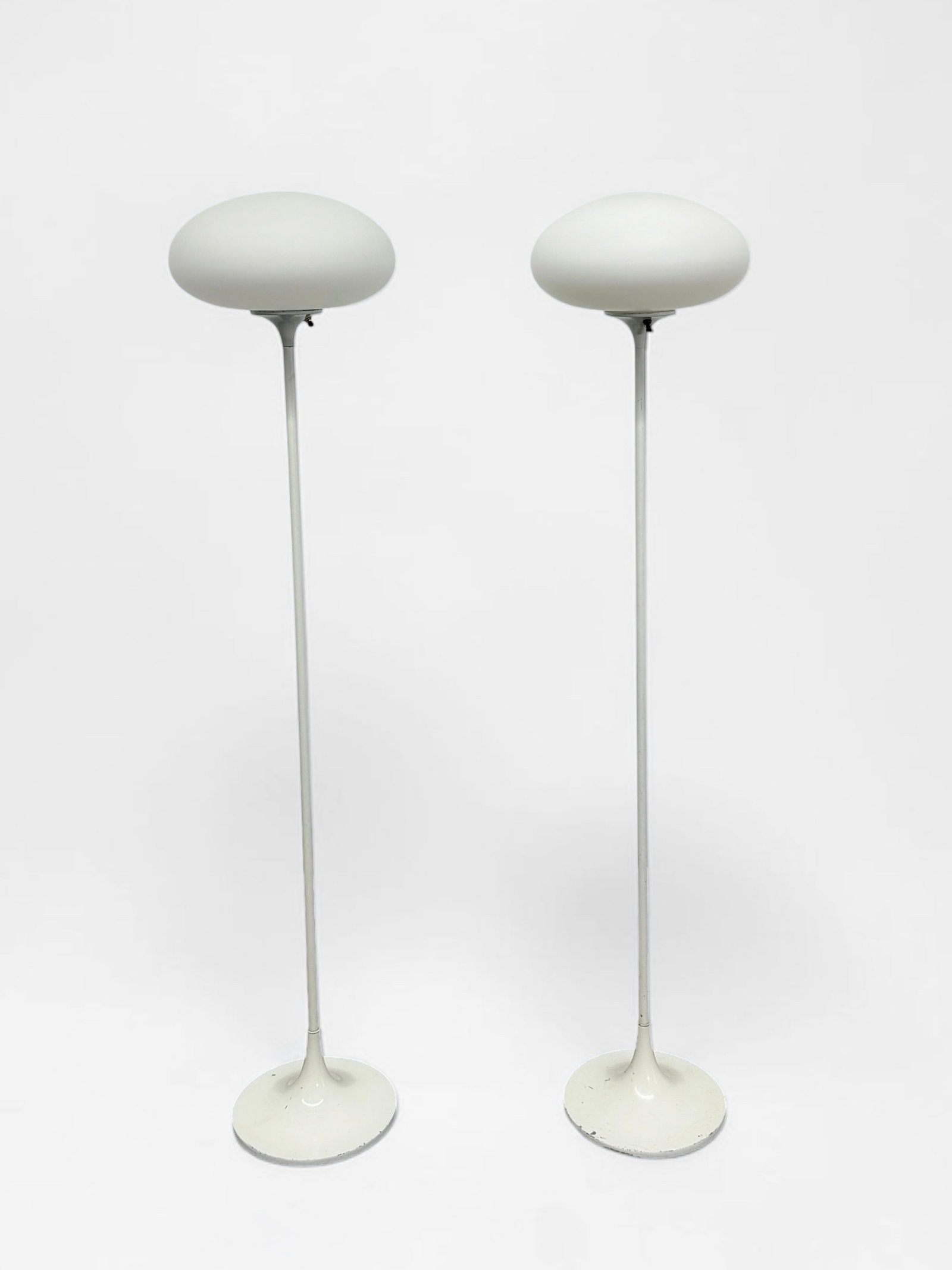 Pair of Mid Century Modern Laurel Lamp Co Mushroom Floor Lamps: Dimensions: 57" Tall x 11" Wide Lamp Shade Condition: Wear to the bases and the stem of the floor lamps. Both light up when plugged in. The wiring should be inspected before