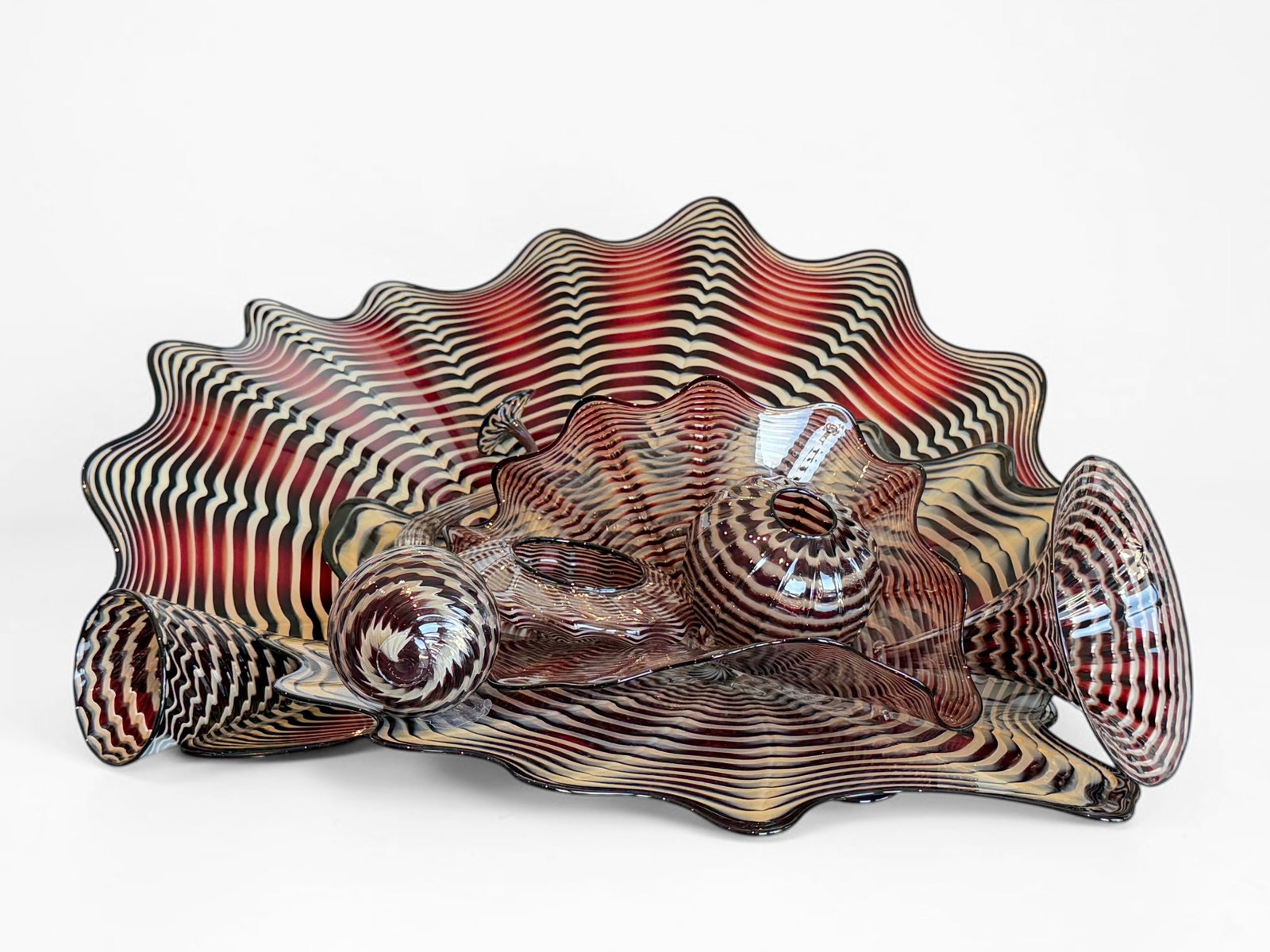 Dale Chihuly "Persian Set" Glass Sculpture: 8 Piece Set. The sculpture comes with a large acrylic vitrine/display case. The sculpture is unsigned. Provenance: Private corporate collection. Total Sculpture Dimension: 10&