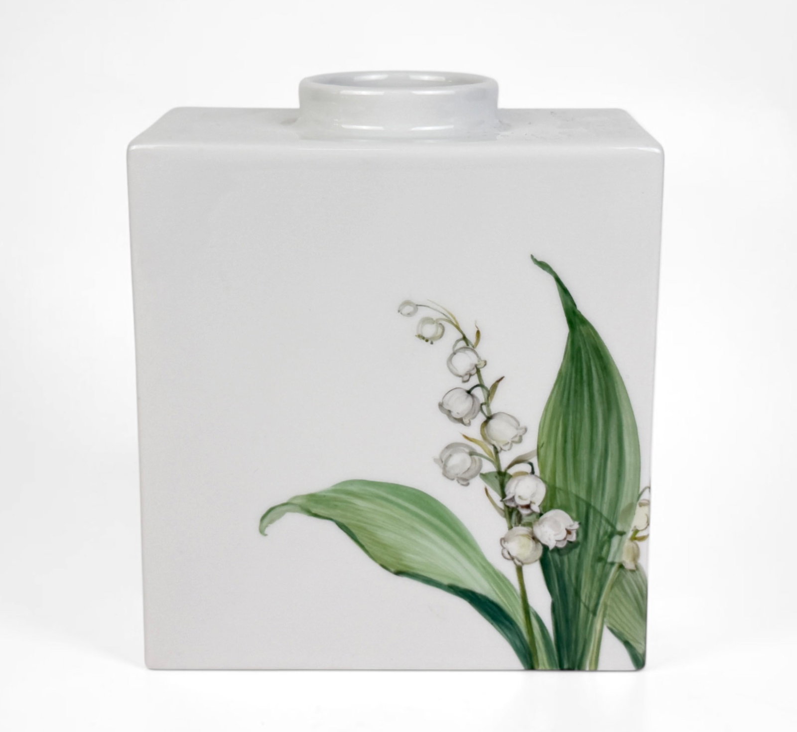 KPM Lily of the Valley Vase: Stamped on the bottom. Dimensions: 5 1/2" Tall x 5" Wide x 2 3/4" Deep Condition: The vase is in very good condition. About: The Konigliche