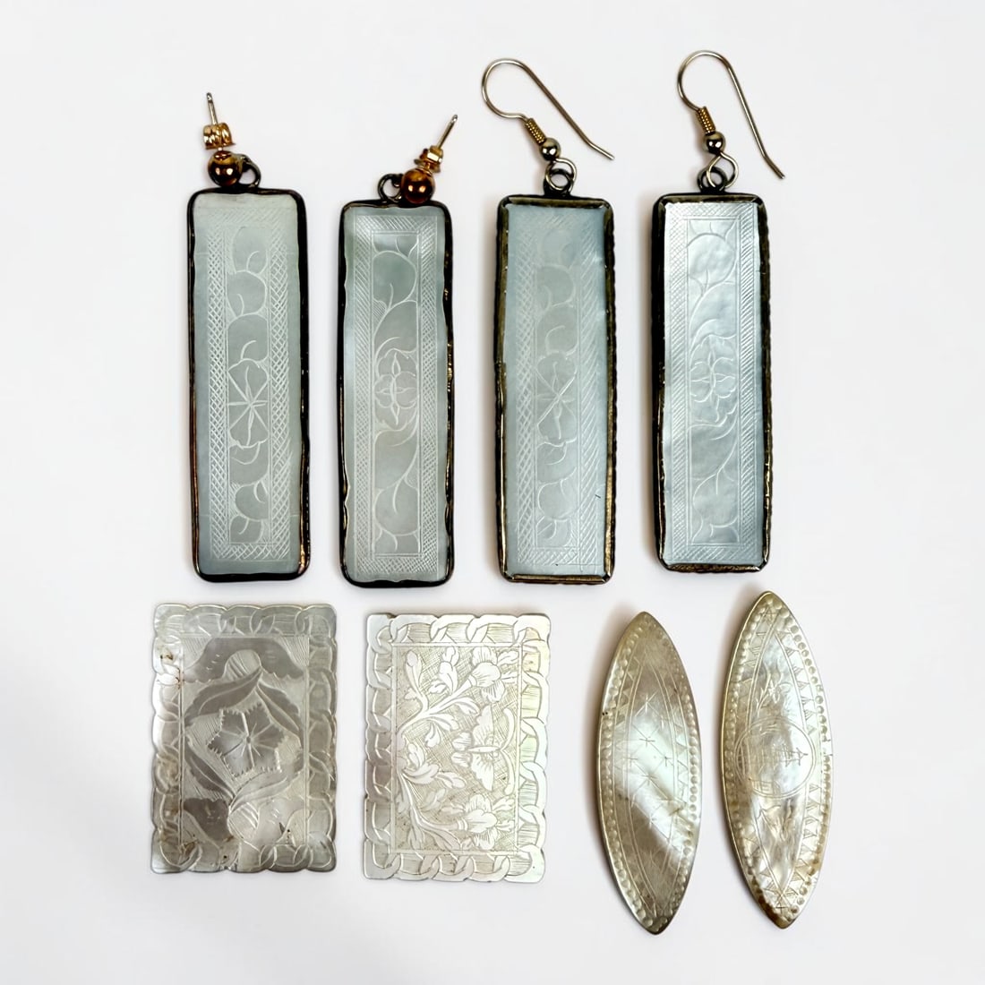 (8) Chinese Mother of Pearl Gaming Chips: Two pairs have been turned into earrings. Length of Longest: 2" Total Weight: 29.2g Condition: Minor wear to the chips and tarnishing to the jewelry components. Please s