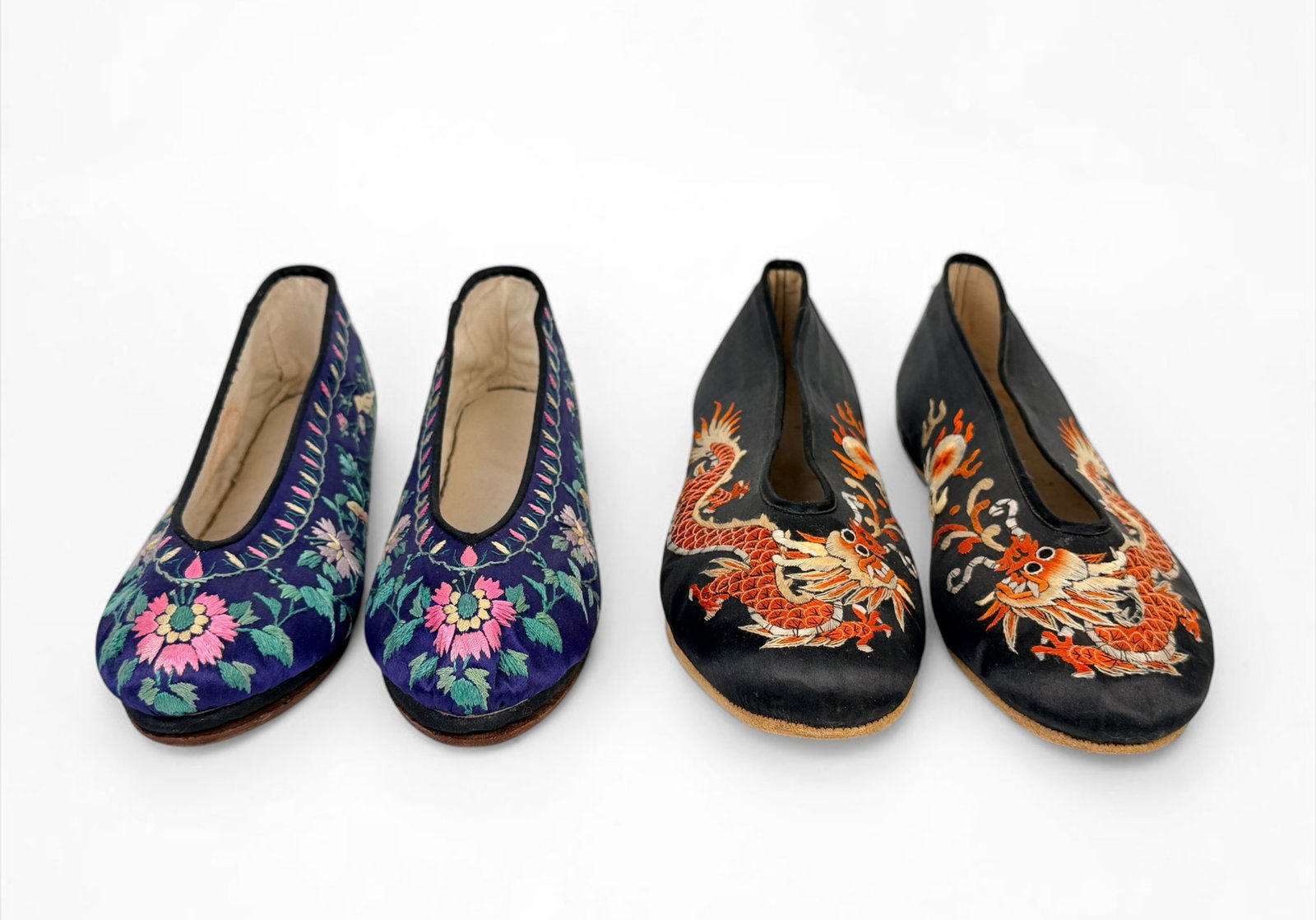 (2) Pairs of Chinese Silk Shoes: Both pairs of shoes are stamped either on the sole or interior side. Both are marked as made in Hong Kong. Length: 10" (black silk) and 9 1/2" (blue silk) Condition