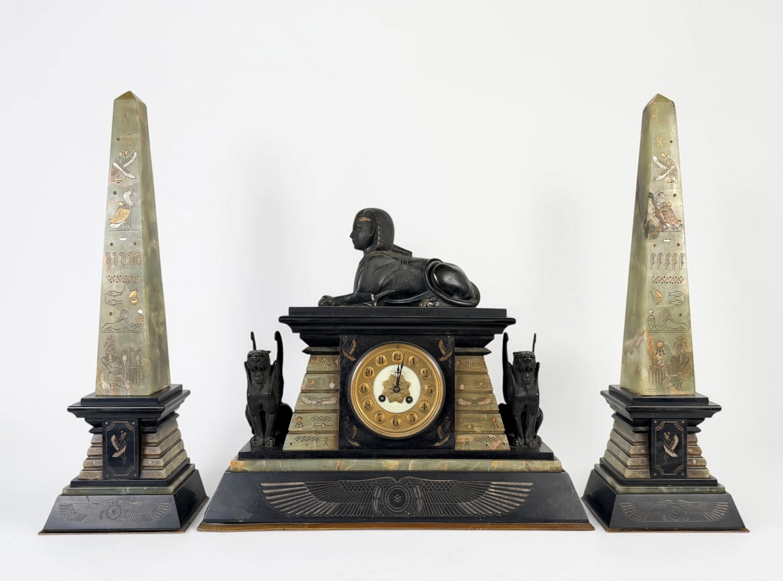 Vintage Egyptian Revival Style Mantel Clock (As Is): The clock is made of black marble, green onyx, and bronze. Dimensions: 17" x 20" x 7" Condition: The clock has wear to the base and will need repairs. There is