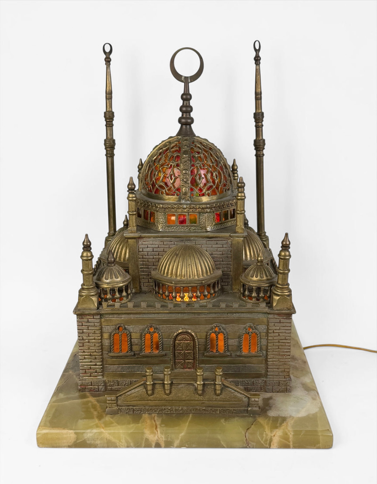 Antique Brass & Marble Model Mosque Lamp: Dimensions: 15 1/2" x 11 1/2" x 13" Condition: One spire needs a replacement screw to be reattached. Scratches to the marble base. Lamp lights up when plugged in. The wirin