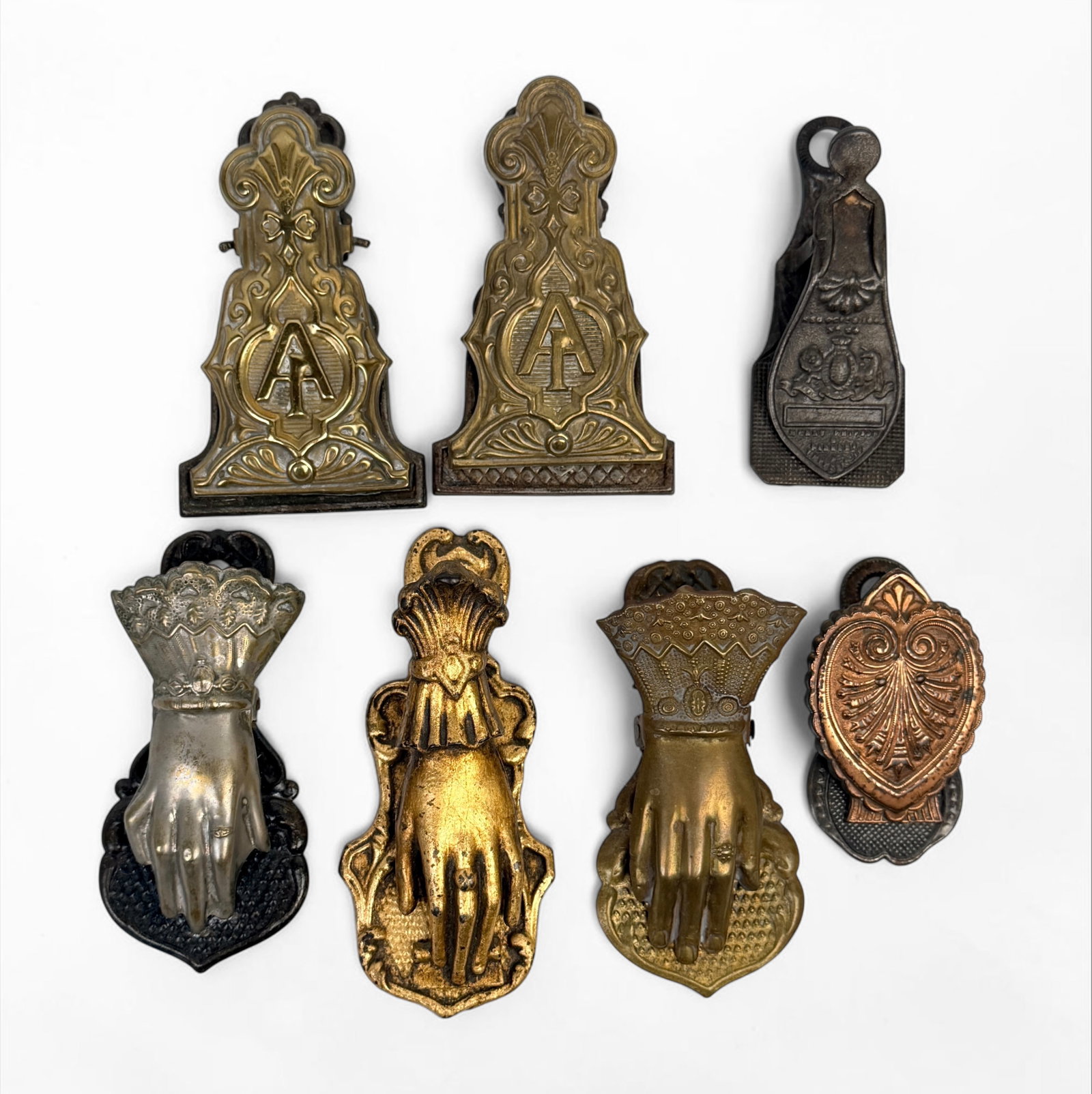(7) Antique Victorian Letter Clips: Made of brass, cast iron, or steel. Largest Clip: 6" x 2 1/2" Condition: Various levels of tarnishing and rust throughout. See images for details. 
