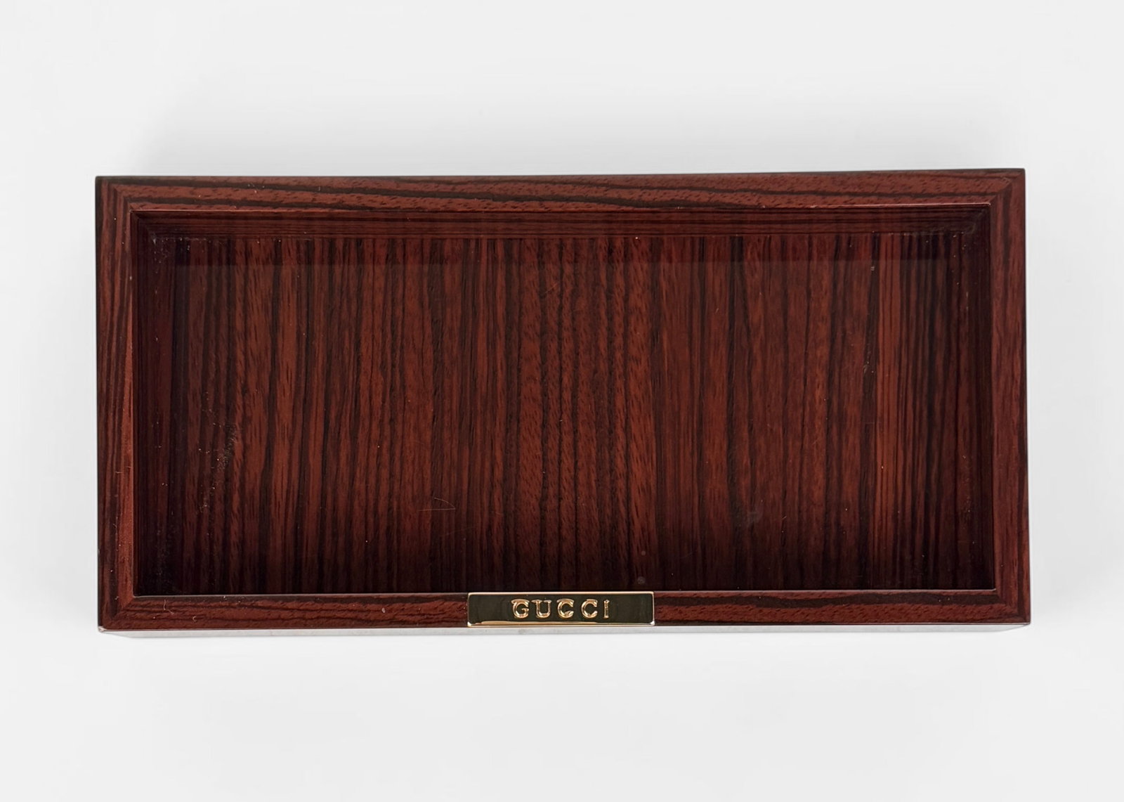 Gucci Rosewood Laminated Catchall: Dimensions: 9 3/4" x 4 3/4" x 1 1/2" Condition: Minor chip to the bottom left corner. Minor scratches throughout the laminate surface, consistent with gentle use. 
