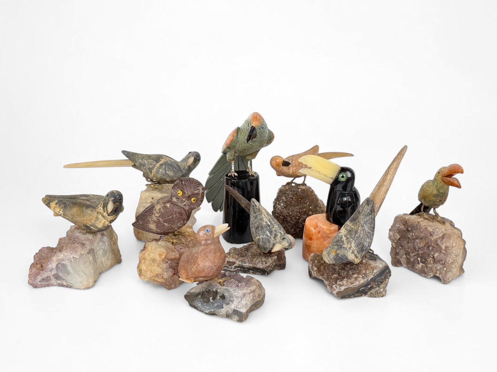 (10) Precious Stone Bird Sculptures: Dimensions: Largest Bird 7 1/2" Tall x 6 1/2" Wide Condition: Two birds have broken tails (the broken pieces are included, but not attached). Minor wear throughout the set. Please see