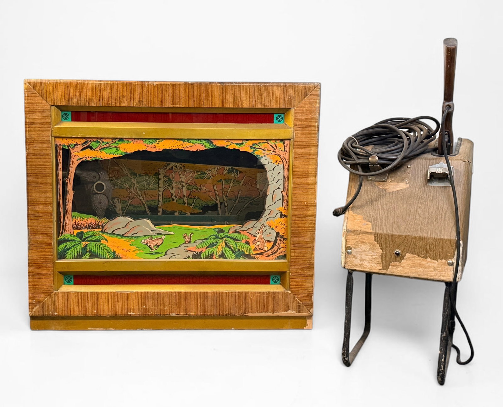 Seeburg "Shoot the Bear" Ray-O-Lite Arcade Rifle Game (B): Dimensions of Cabinet: 42" W x 36 1/2" T x 20" D Condition: Wear and loss of paint to the cabinet throughout. The key for the cabinet is broken. The backdrop is loose and n