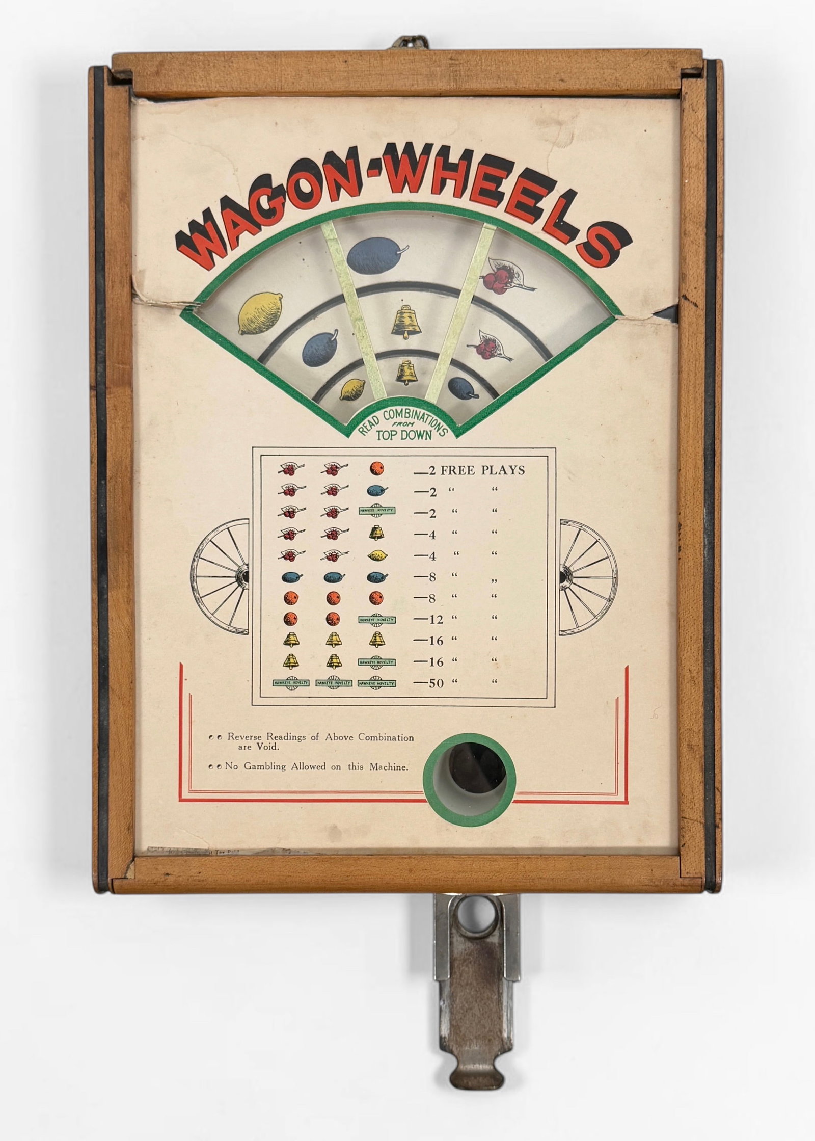 1930s "Wagon Wheels" Countertop Trade Simulator: Dimensions: 10 1/2" W x 14" T x 4 1/2" D (not including coin slot) Condition: The top hatch is not fully attached. Wear and surface marks to the exterior wood. The