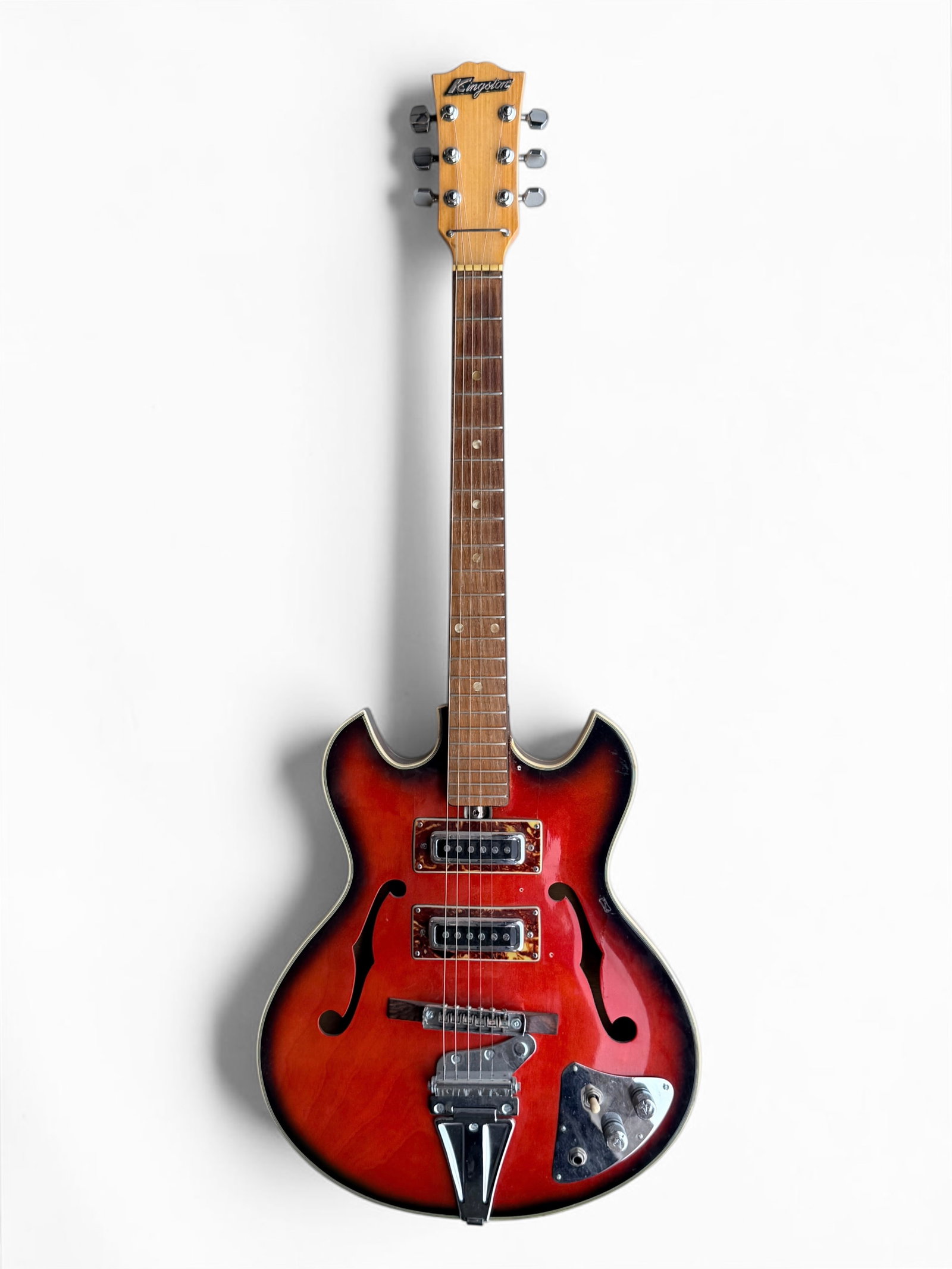 1960s Kingston Semi-Hollowbody Electric Guitar: Comes in a hard case. Serial Number: N/A Length: 39" Condition: One string is missing. There are scratches throughout the body of the guitar, some allowing the paint to 